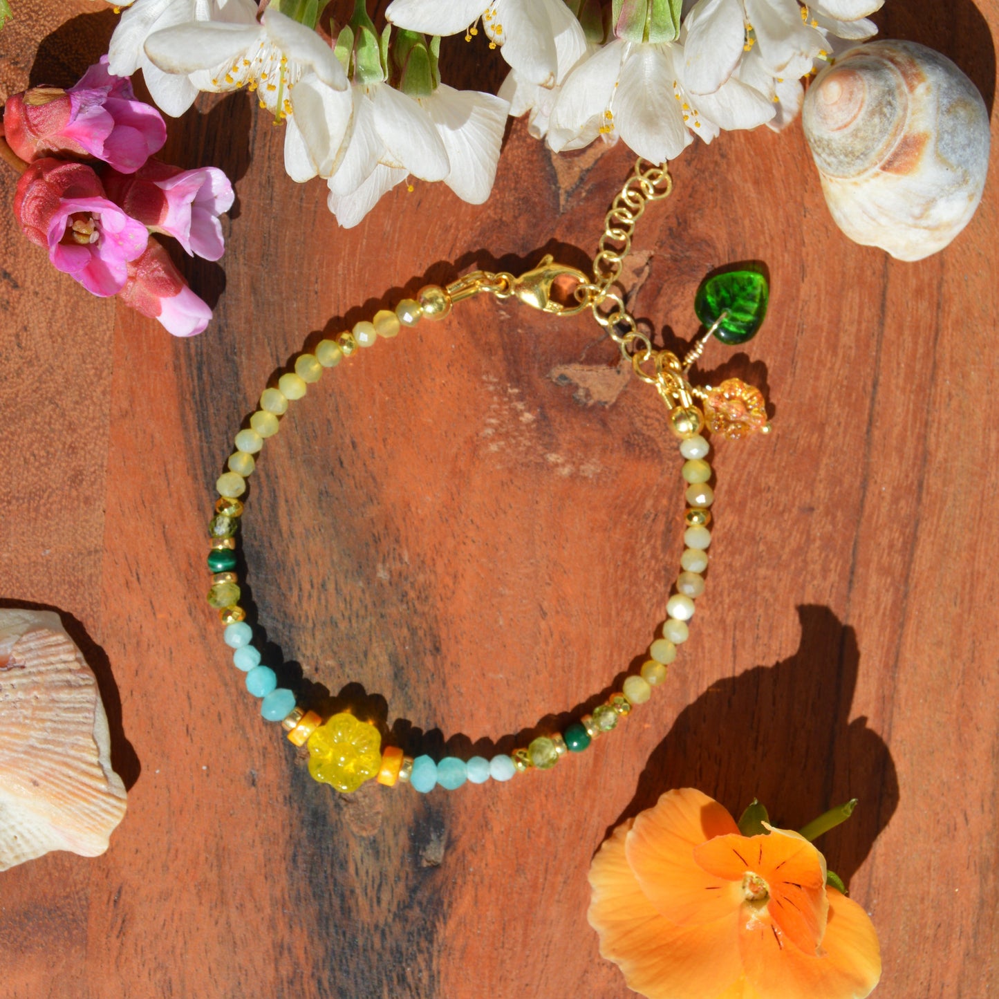 Gold-plated sterling silver gemstone bracelet featuring yellow opal, olivine, malachite, amazonite, turquoise, jasper, and hematite. Czech glass bead flowers and leaf as a decoration. Extension chain.