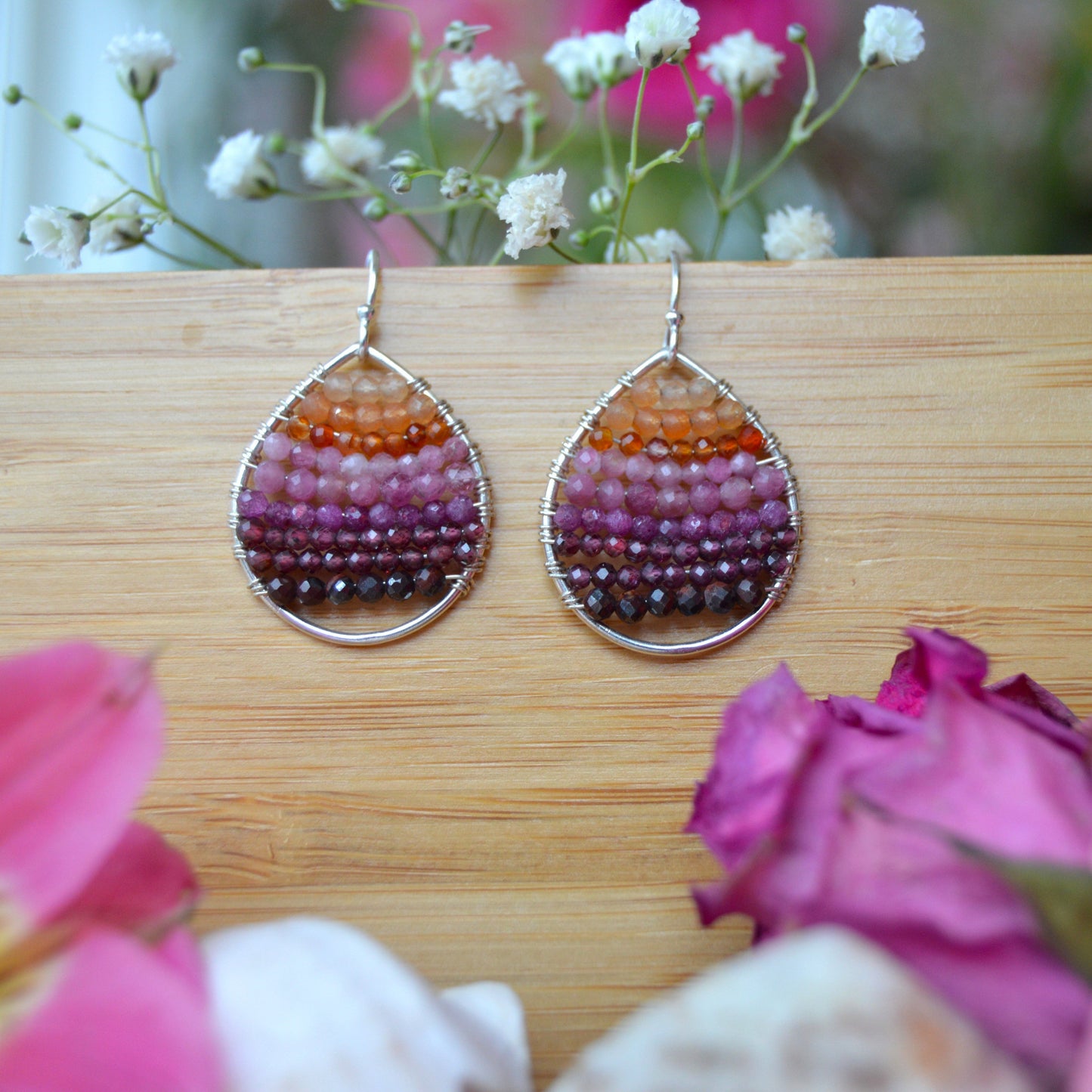 Sterling silver drop earrings wire-wrapped with gemstones.