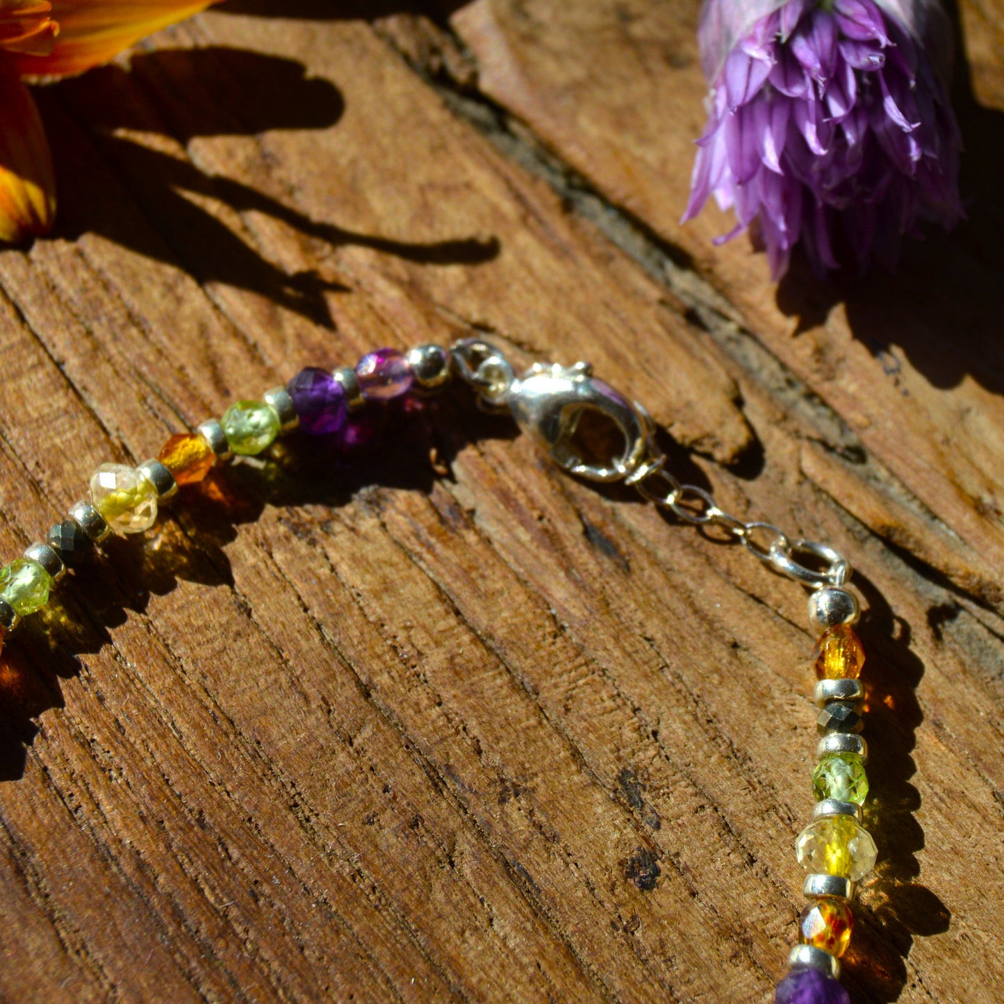 Sterling silver boho bracelet fearing gemstones and Czech faceted beads alongside Japanese glass beads.