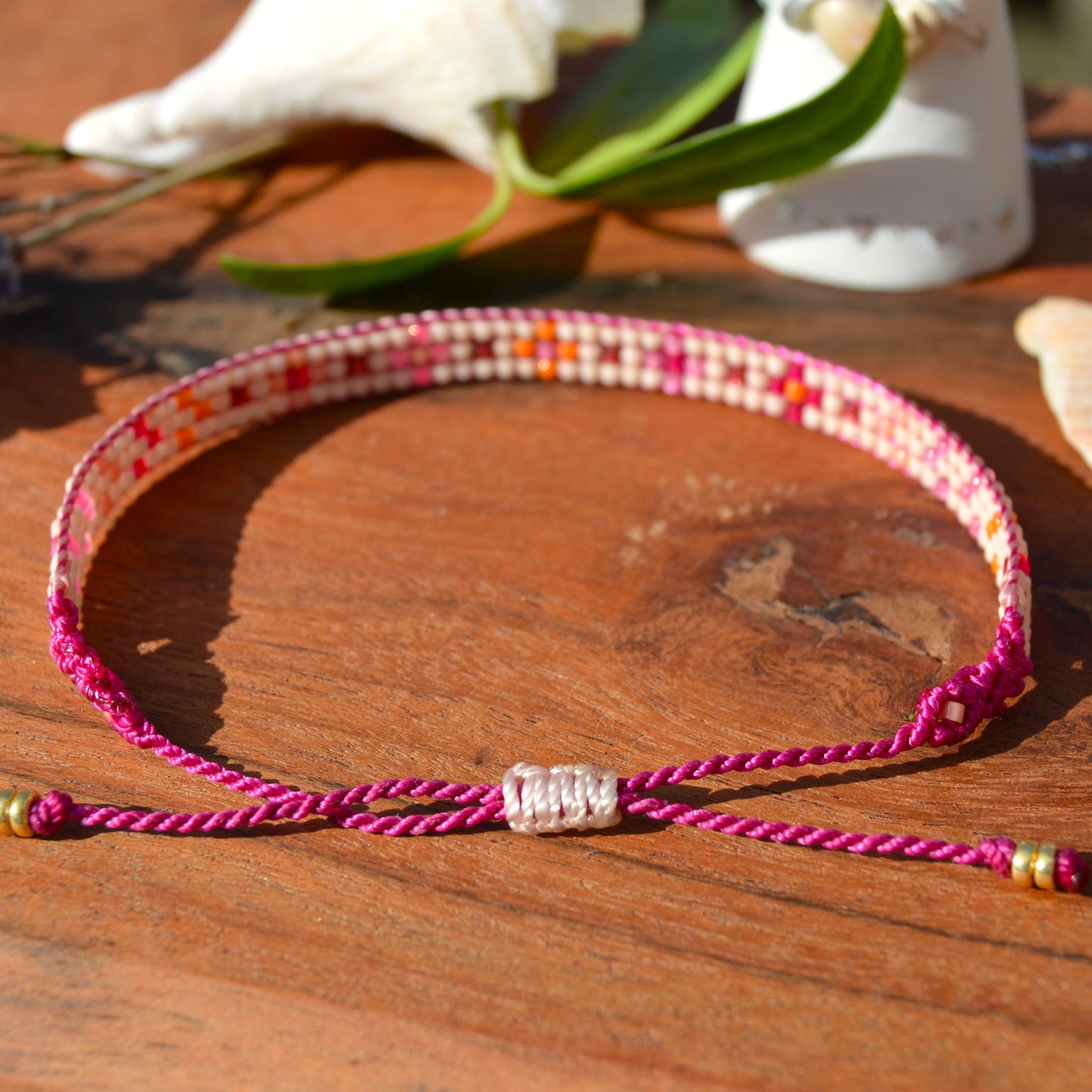 Woven beaded bracelet made of Japanese seed beads with macrame details.