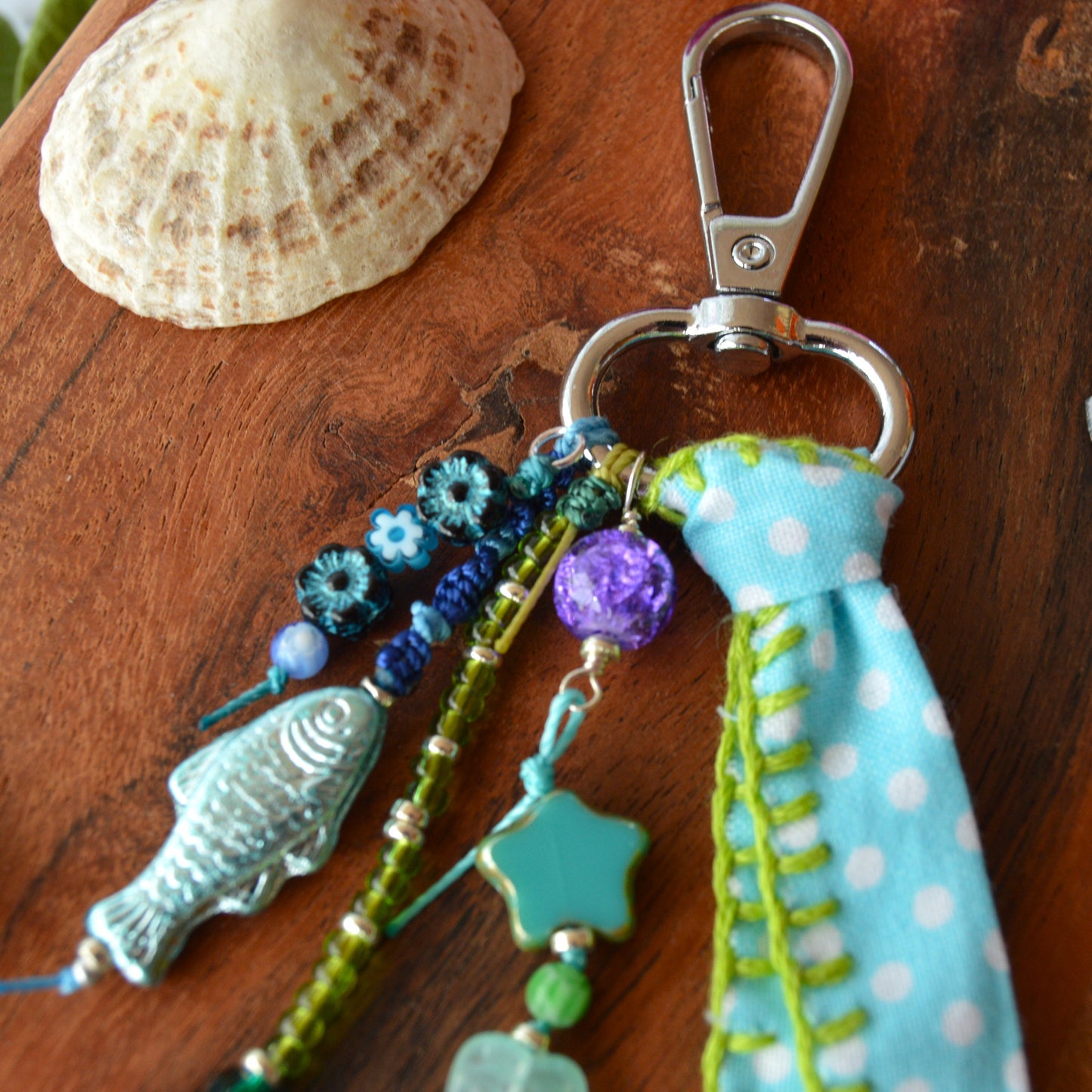 One of a kind colourful bag charm with a glass beads in blue and green tones.