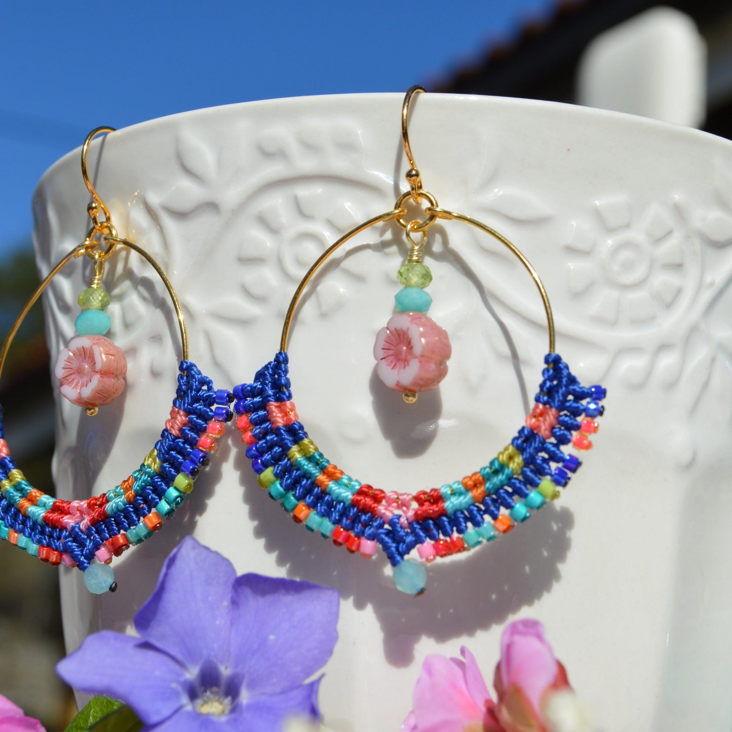 Colourful gold-plated sterling silver hoop earring decorated with micro macrame, Japanese seed beads, and amazonite gemstone. Czech glass flower charm with turquoise and olivine gemstones.