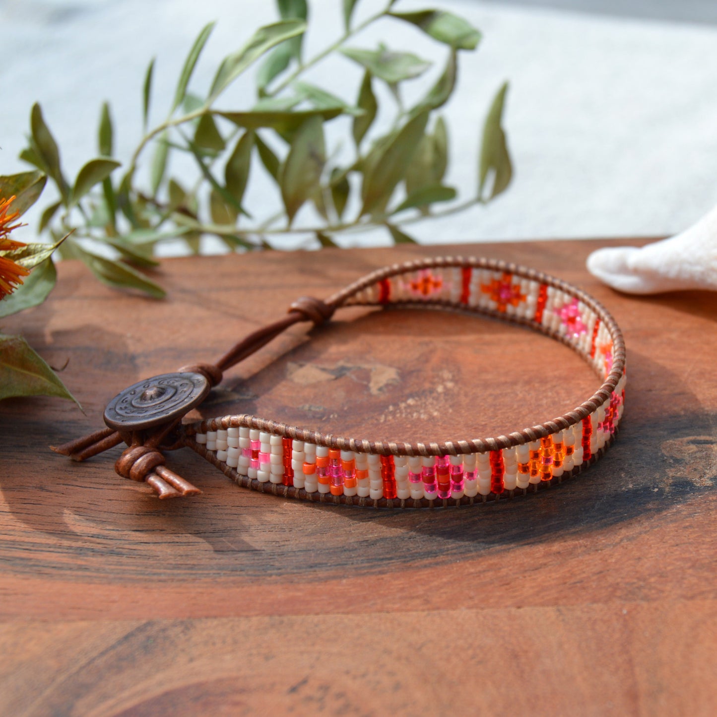 Boho leather wrap with woven Japanese seed beads and a button as a lock. Extension in leather.