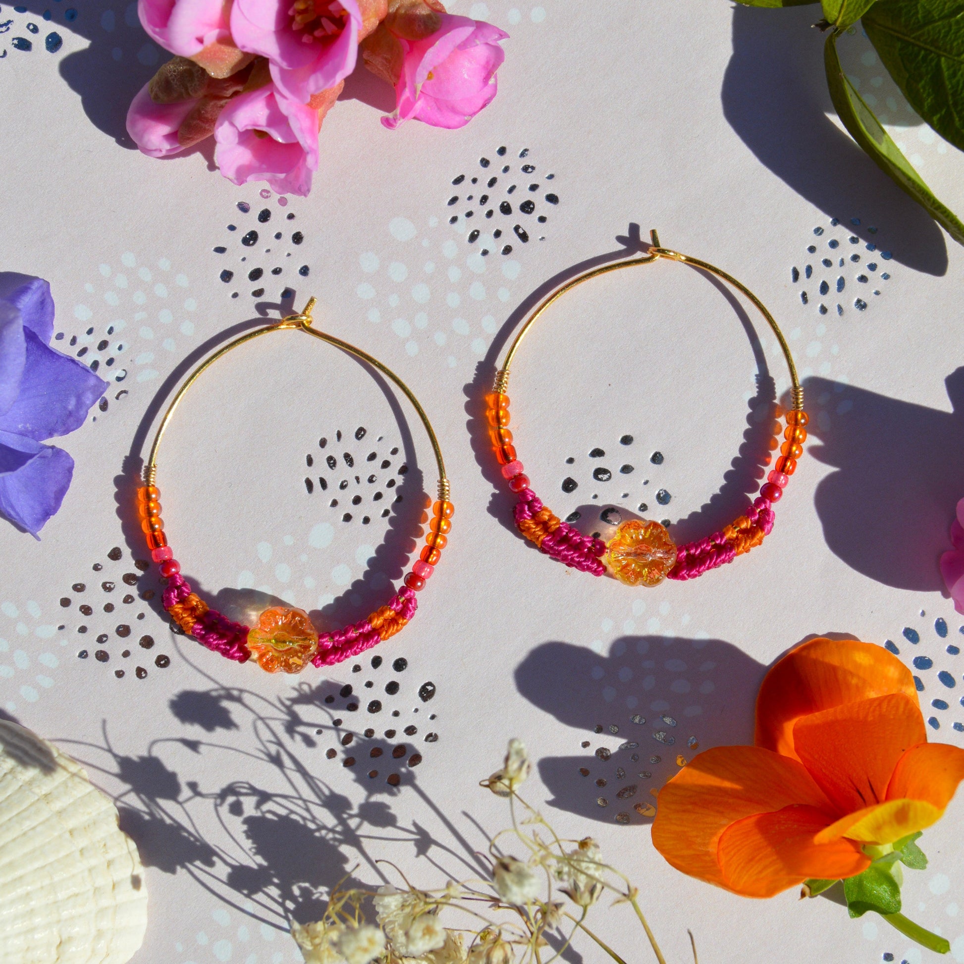 Colorful gold-plated sterling silver creoles decorated with micro macrame, Czech glass seed beads and Czech glass flower bead in the center.