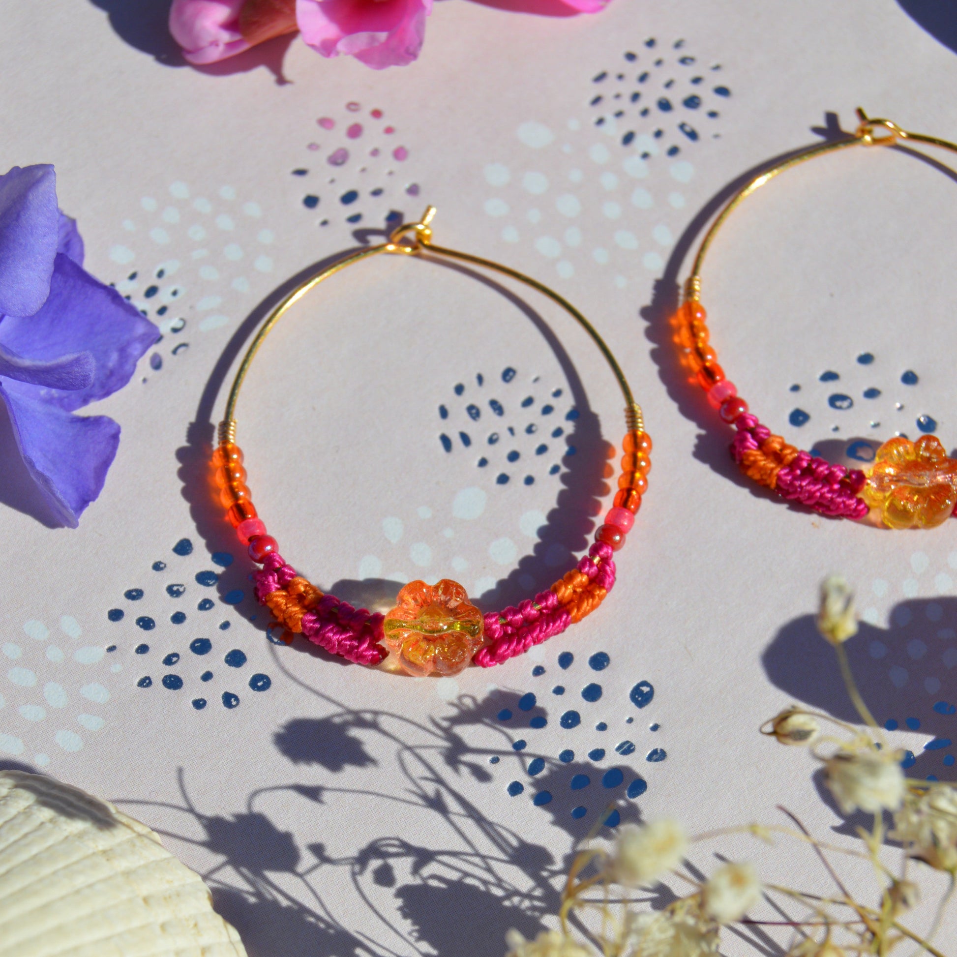 Colorful gold-plated sterling silver creoles decorated with micro macrame, Czech glass seed beads and Czech glass flower bead in the center.