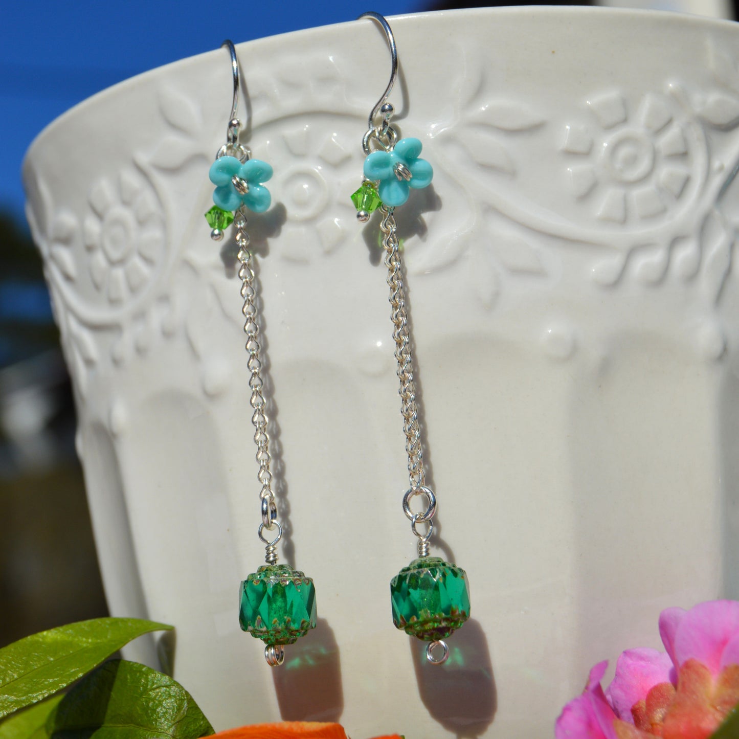 Sterling silver earring featuring Czech glass bead in green, lampwork flower and Czech glass faceted bicone.