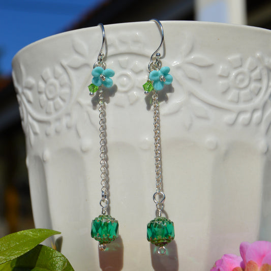 Sterling silver earring featuring Czech glass bead in green, lampwork flower and Czech glass faceted bicone.