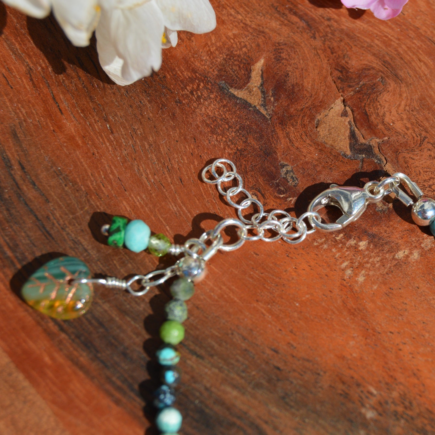 Sterling silver gemstone bracelet with Czech glass flower in the center. Blue Lagon.