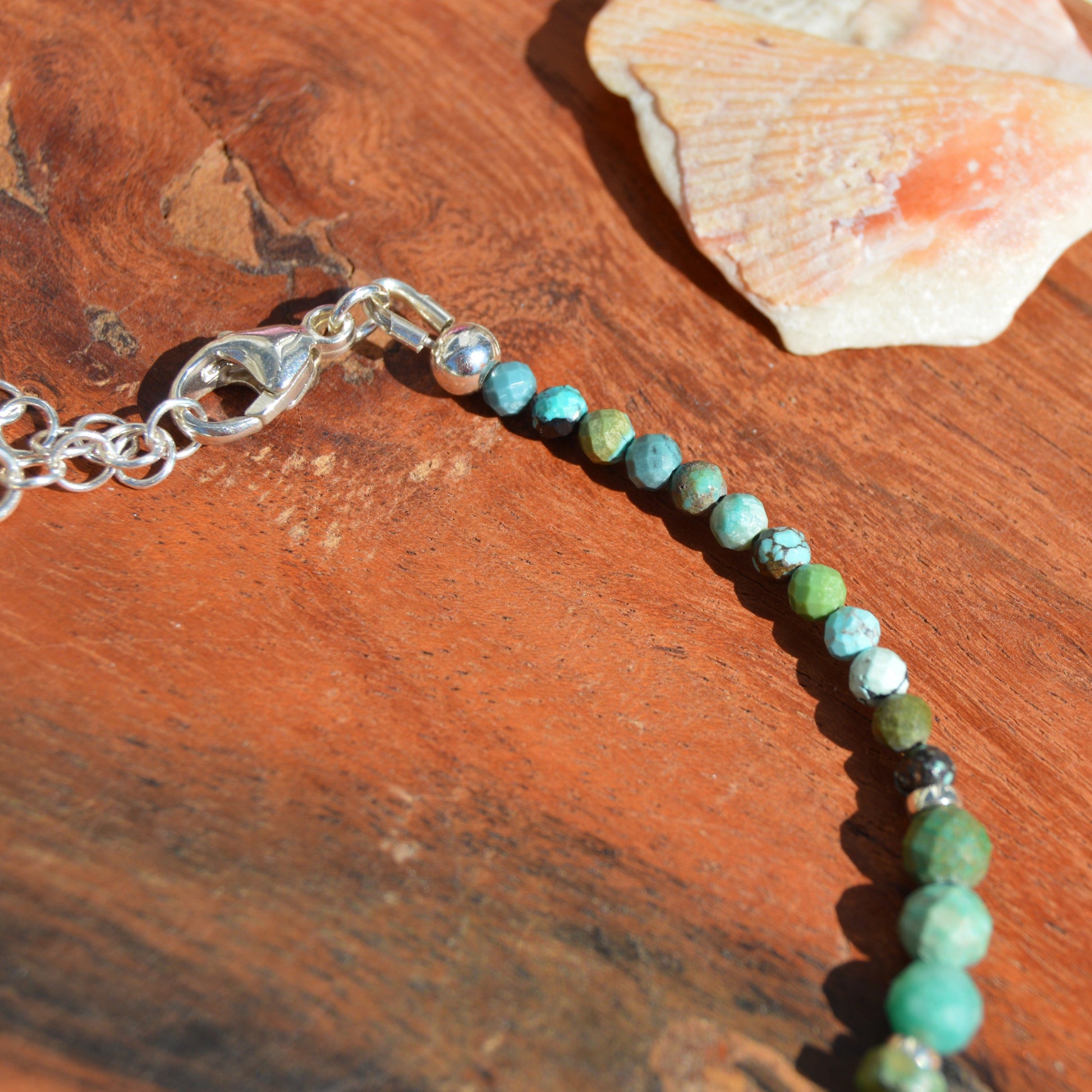 Sterling silver gemstone bracelet with Czech glass flower in the center. Blue Lagon.
