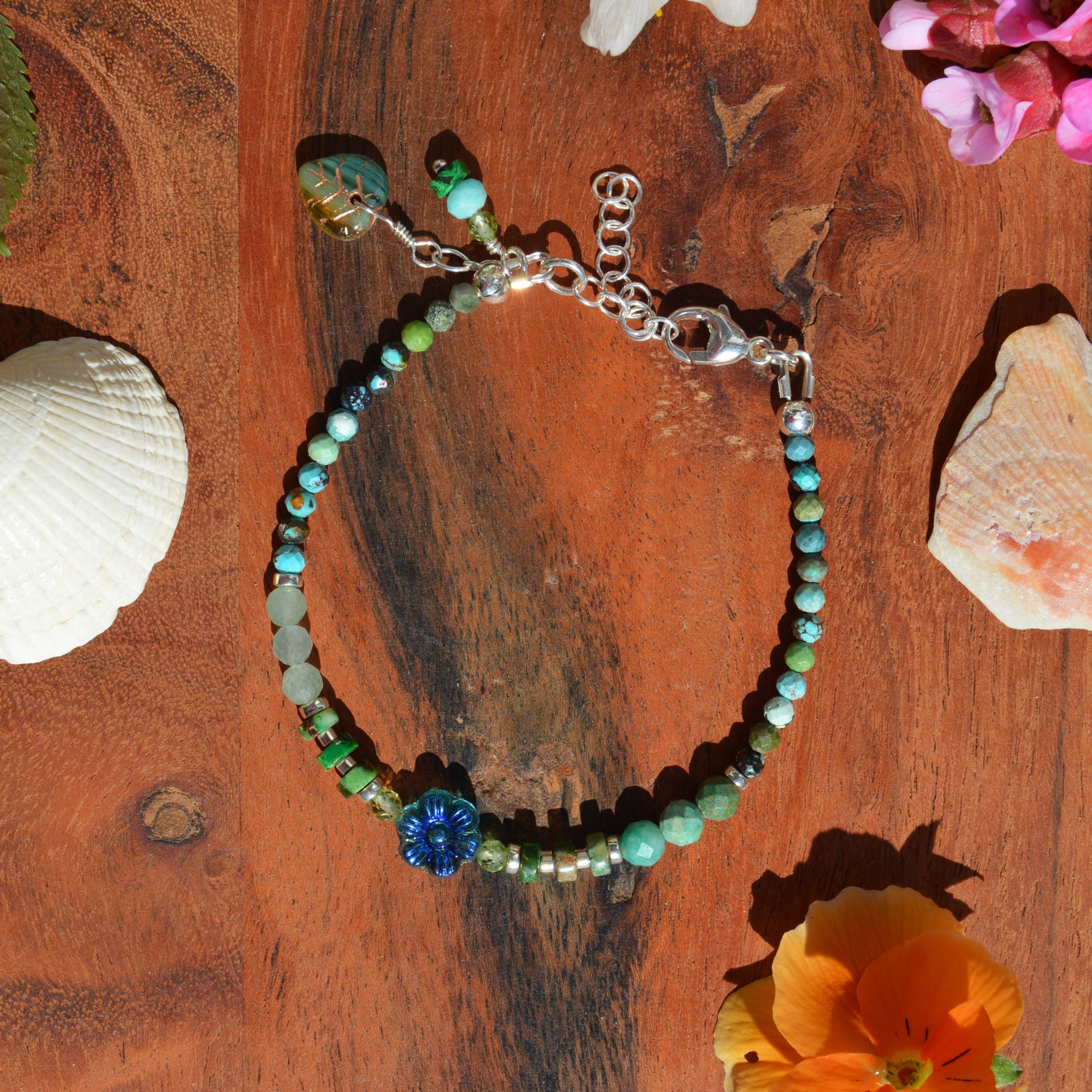 Sterling silver gemstone bracelet with Czech glass flower in the center. Blue Lagon.