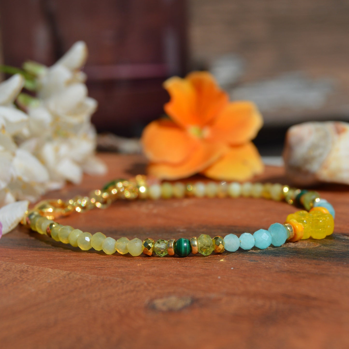 Gold-plated sterling silver gemstone bracelet featuring yellow opal, olivine, malachite, amazonite, turquoise, jasper, and hematite. Czech glass bead flowers and leaf as a decoration. Extension chain.