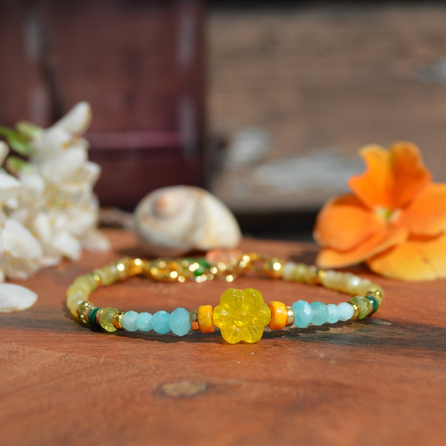 Gold-plated sterling silver gemstone bracelet featuring yellow opal, olivine, malachite, amazonite, turquoise, jasper, and hematite. Czech glass bead flowers and leaf as a decoration. Extension chain.
