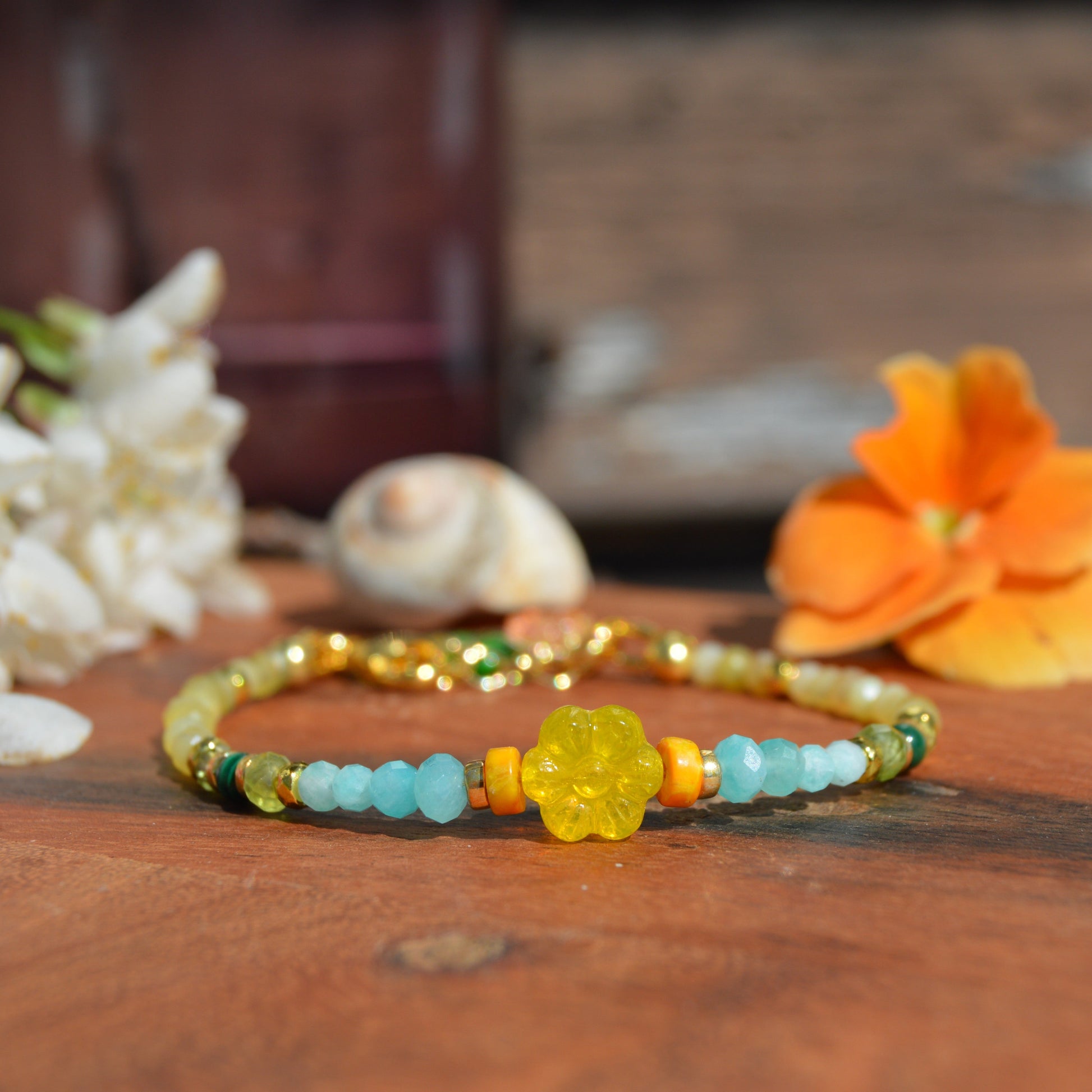 Gold-plated sterling silver gemstone bracelet featuring yellow opal, olivine, malachite, amazonite, turquoise, jasper, and hematite. Czech glass bead flowers and leaf as a decoration. Extension chain.