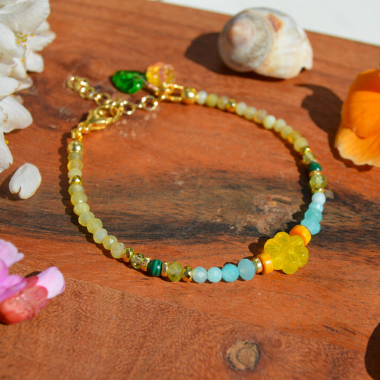 Gold-plated sterling silver gemstone bracelet featuring yellow opal, olivine, malachite, amazonite, turquoise, jasper, and hematite. Czech glass bead flowers and leaf as a decoration. Extension chain.