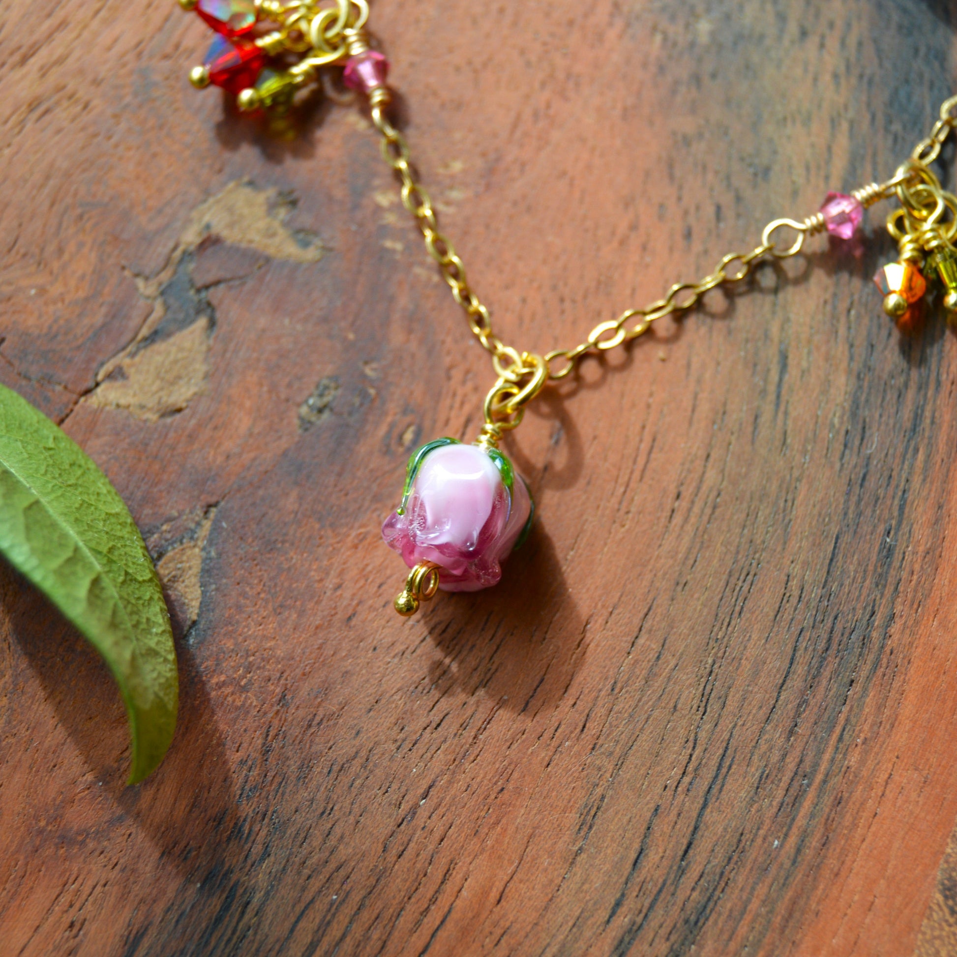 One of a kind gold-plated sterling silver necklace with glass flower & faceted bicones charms. Colourful. 