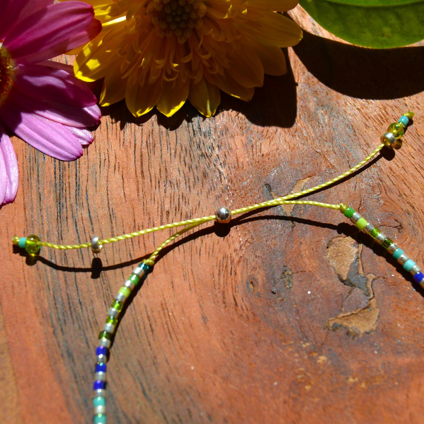 Adjustable, colourful beaded bracelet with silicone stopper bead.