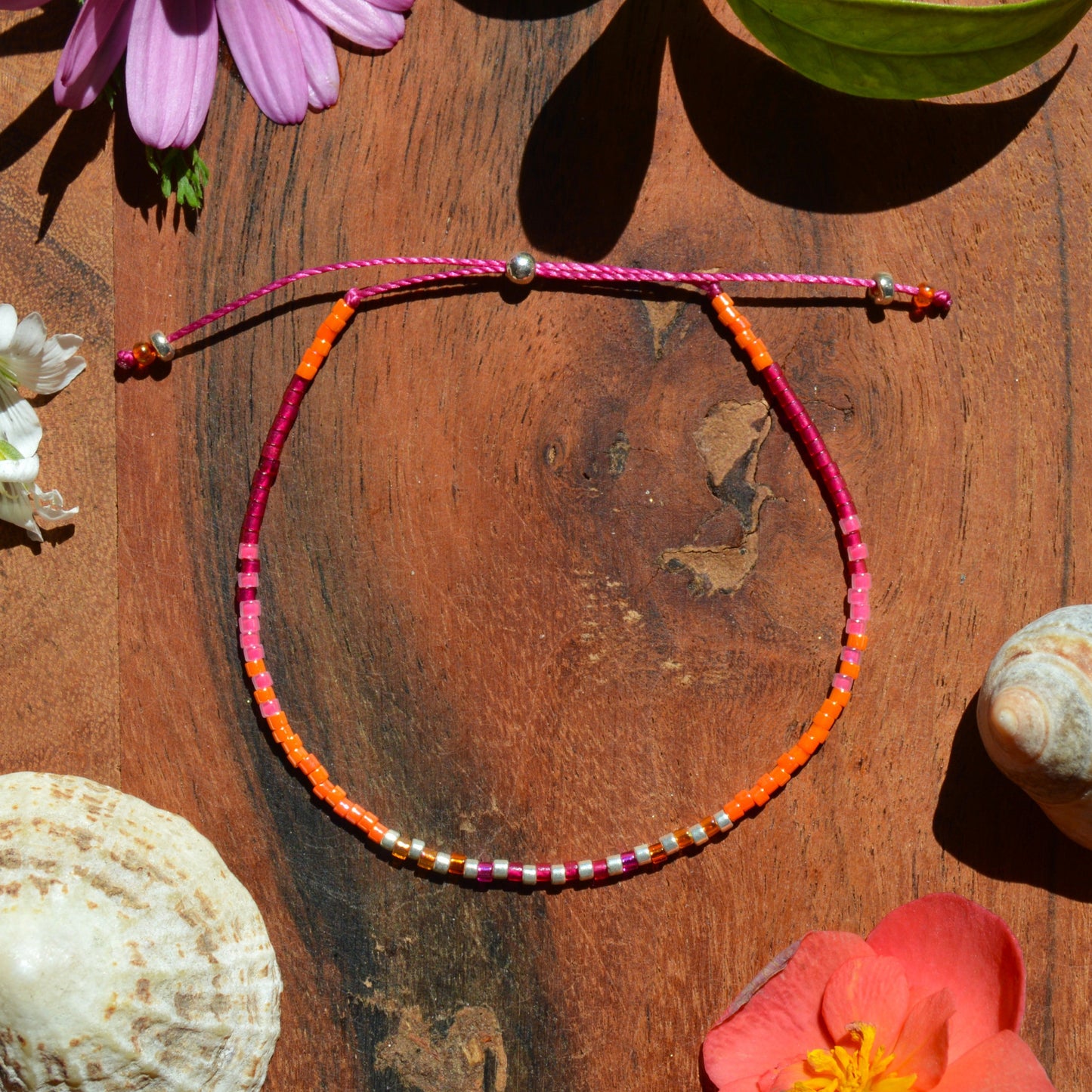 Adjustable, colourful beaded bracelet made of Japanese seed beads with silicon stopper bead.