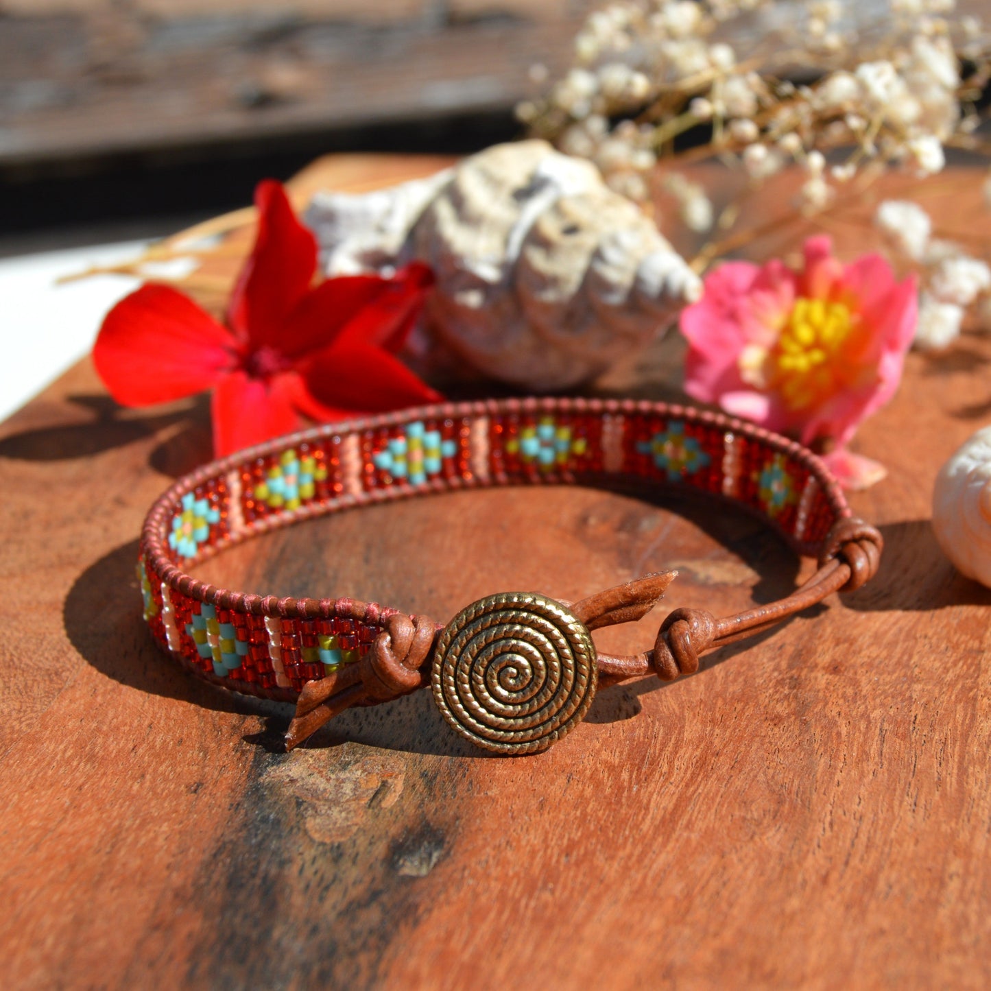 Leather wrap beaded bracelet with geometric pattern, button as a lock and extension chain in leather.