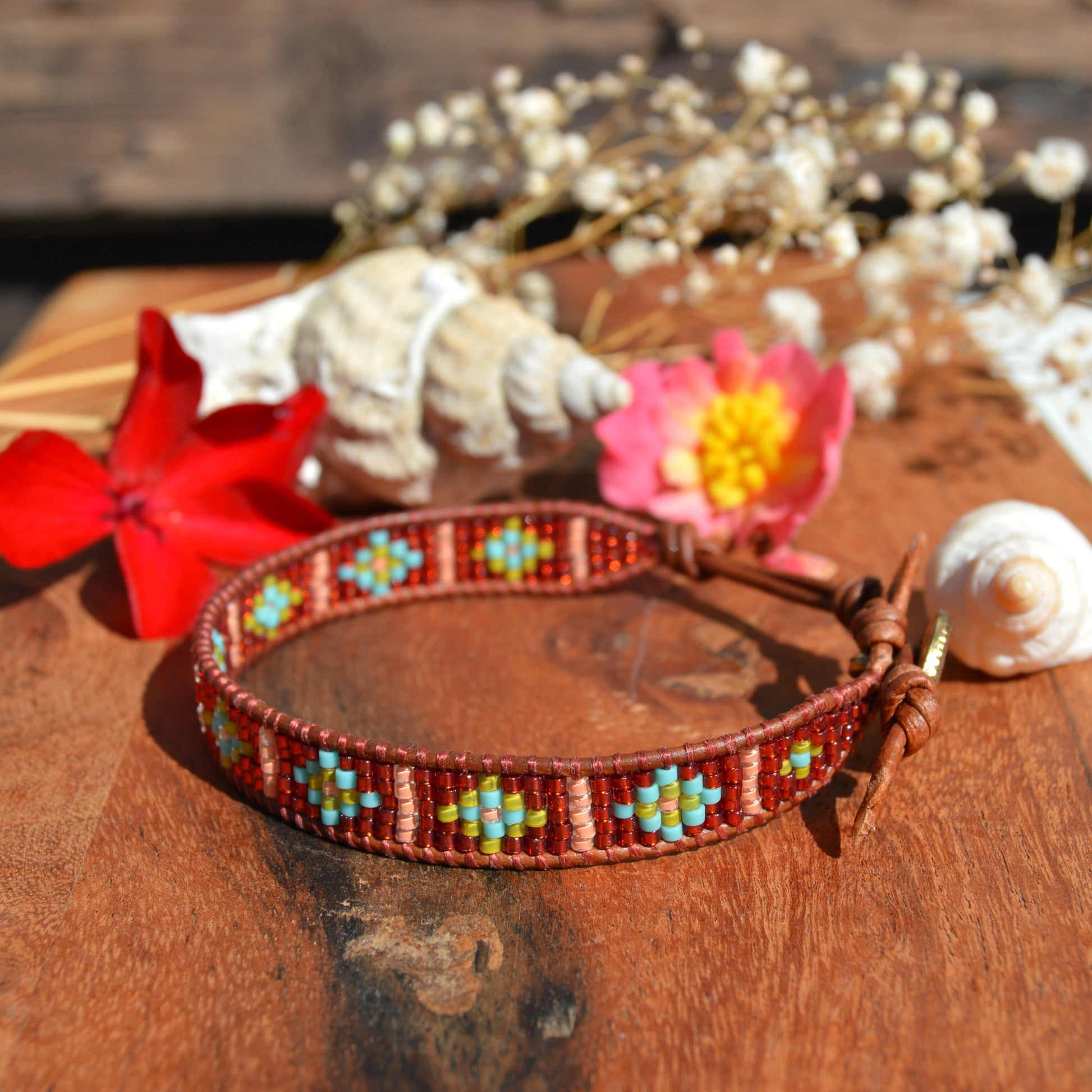 Leather wrap beaded bracelet with geometric pattern, button as a lock and extension chain in leather.