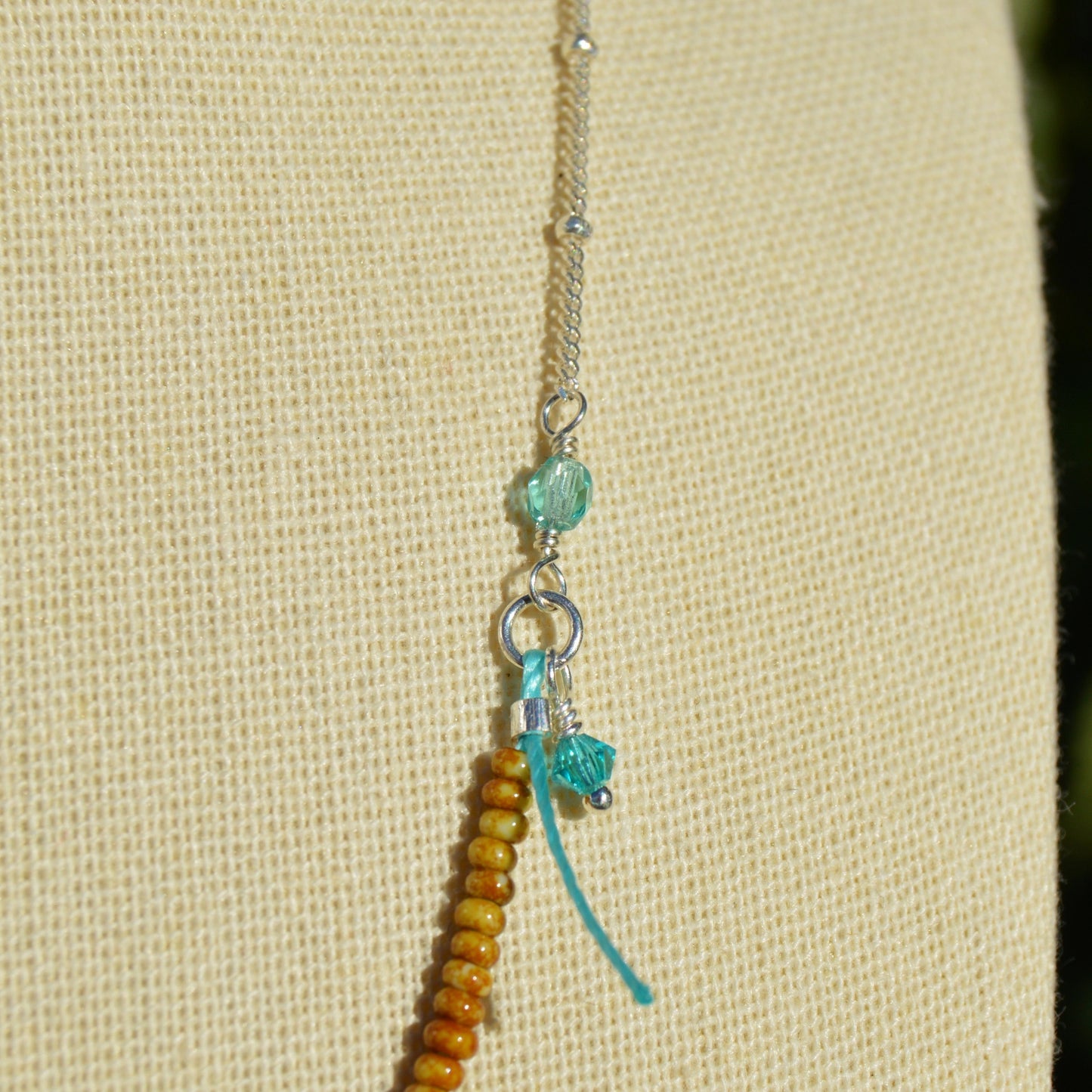 Beaded necklace with turtle charm in sterling silver. Closer to the Sea.