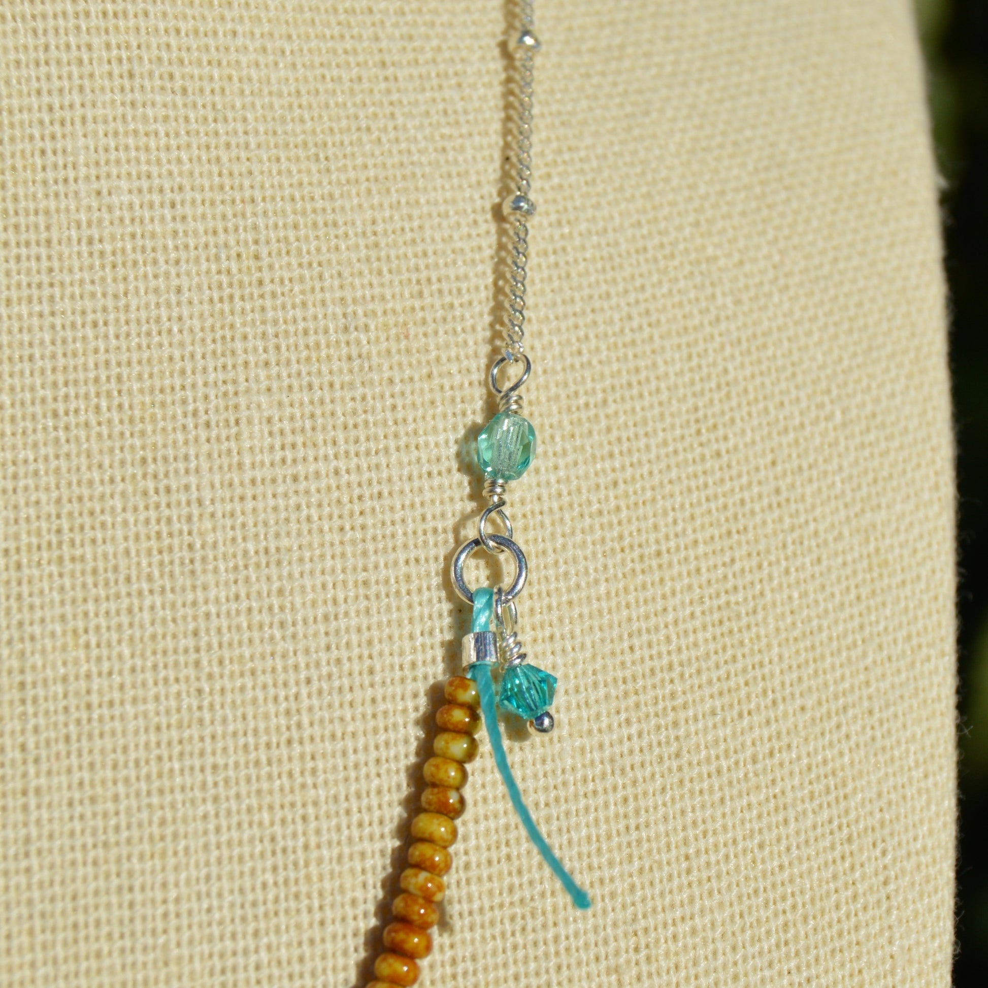 Beaded necklace with turtle charm in sterling silver. Closer to the Sea.