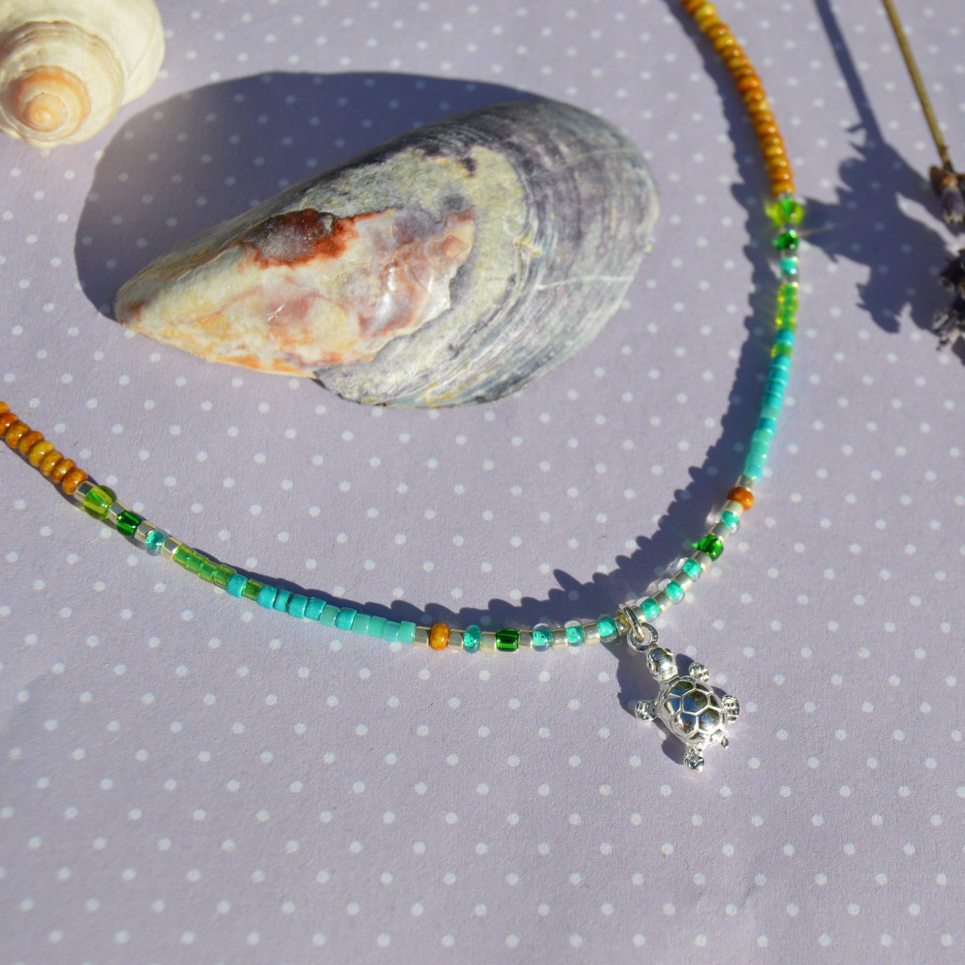 Beaded necklace with turtle charm in sterling silver. Closer to the Sea.