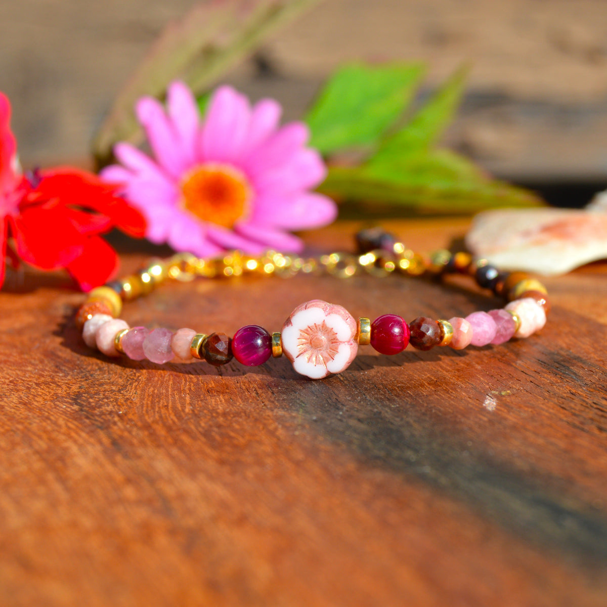 Gemstone bracelet in pink, beige, and brown town. Gold-plated sterling silver, and pink flower glass bead.