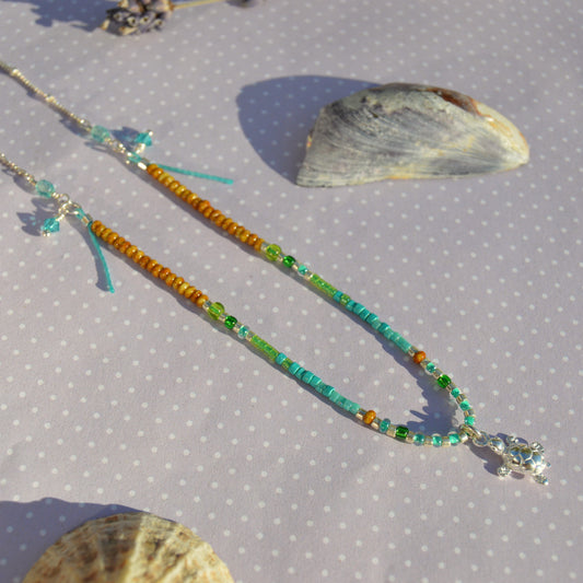 Beaded necklace with turtle charm in sterling silver. Closer to the Sea.