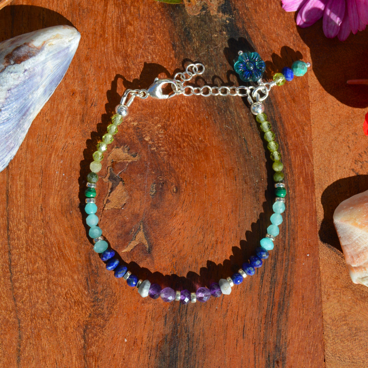 Gemstone bracelet in sterling silver in violet, blue, and green tones.