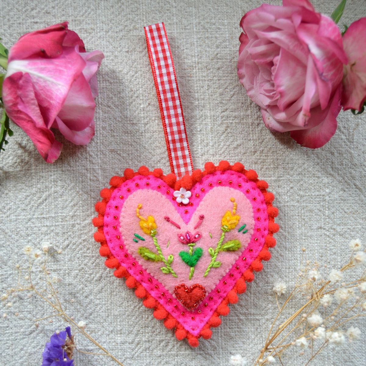Embroidered Wool Folklore Heart with flower motif, decorated with glass seed beads.