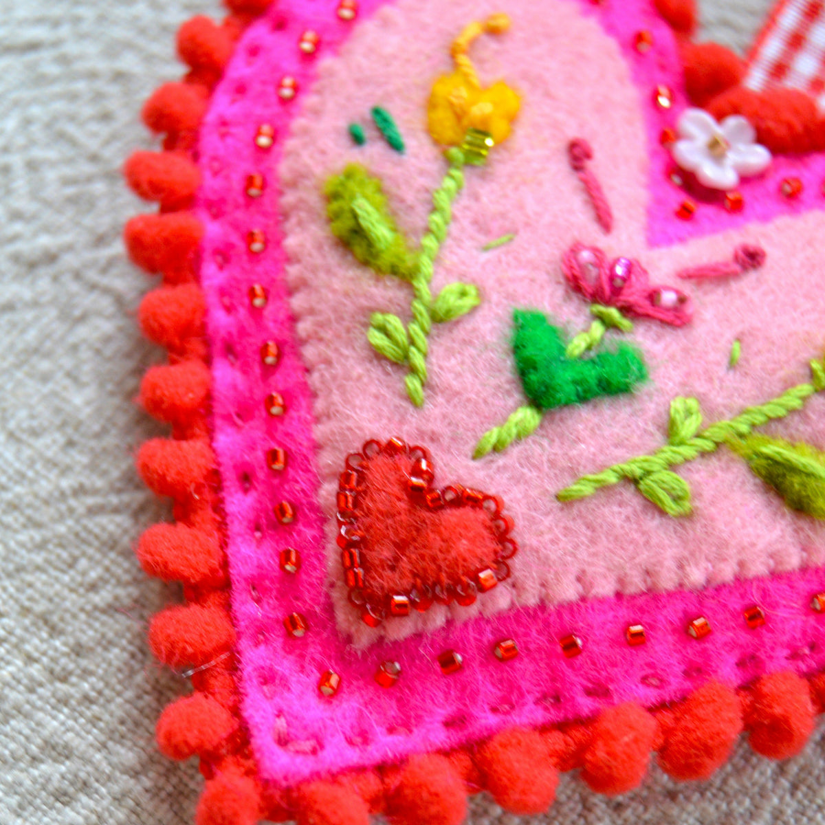 Embroidered Wool Folklore Heart with flower motif, decorated with glass seed beads.