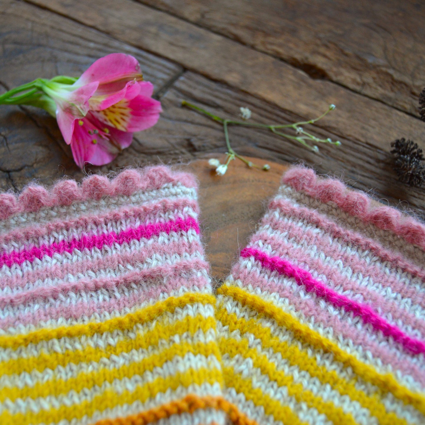 Alpakka wool pulse warmers in soft colours with  colourful stripes.