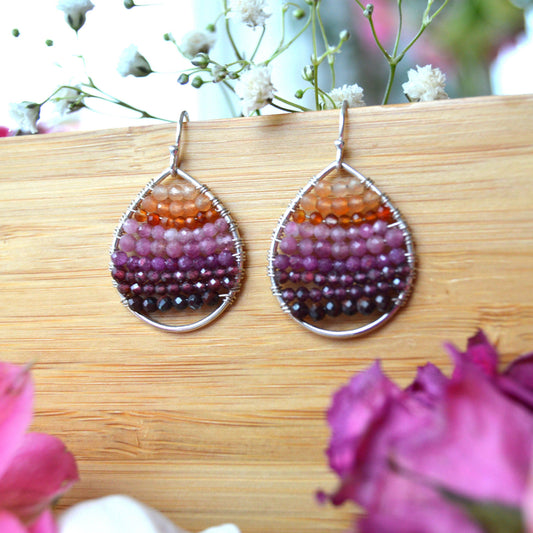 Sterling silver drop earrings wire-wrapped with gemstones.