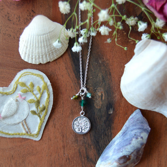 Sterling silver necklace decorated with Tree of Life charm and Czech faceted glass bicones and a crystal.