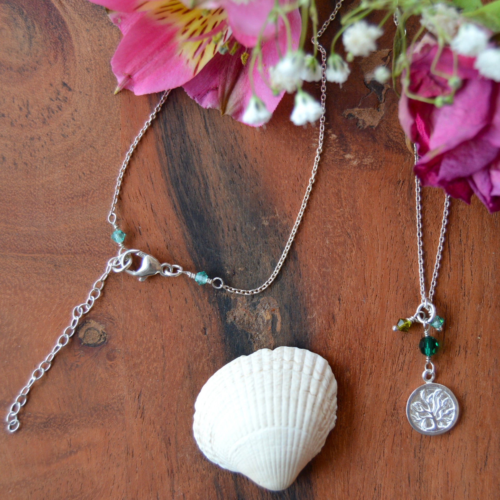 Sterling silver necklace decorated with Tree of Life charm and Czech faceted glass bicones and a crystal.