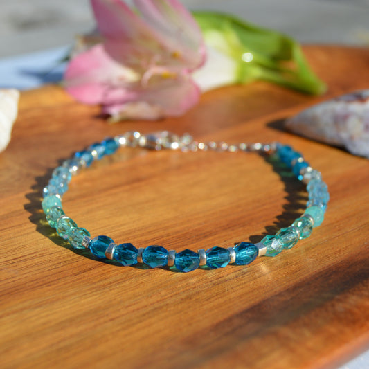 Sterling silver bracelet made of Czech glass beads in blue tones.