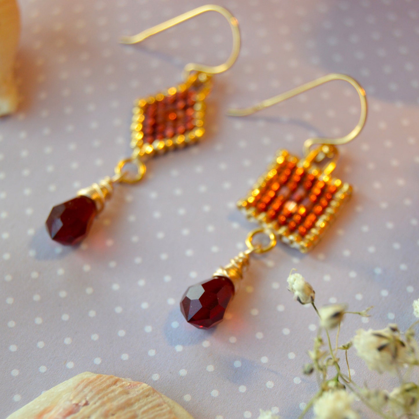 Scheherazade woven earrings with the different designs combined in one pair.