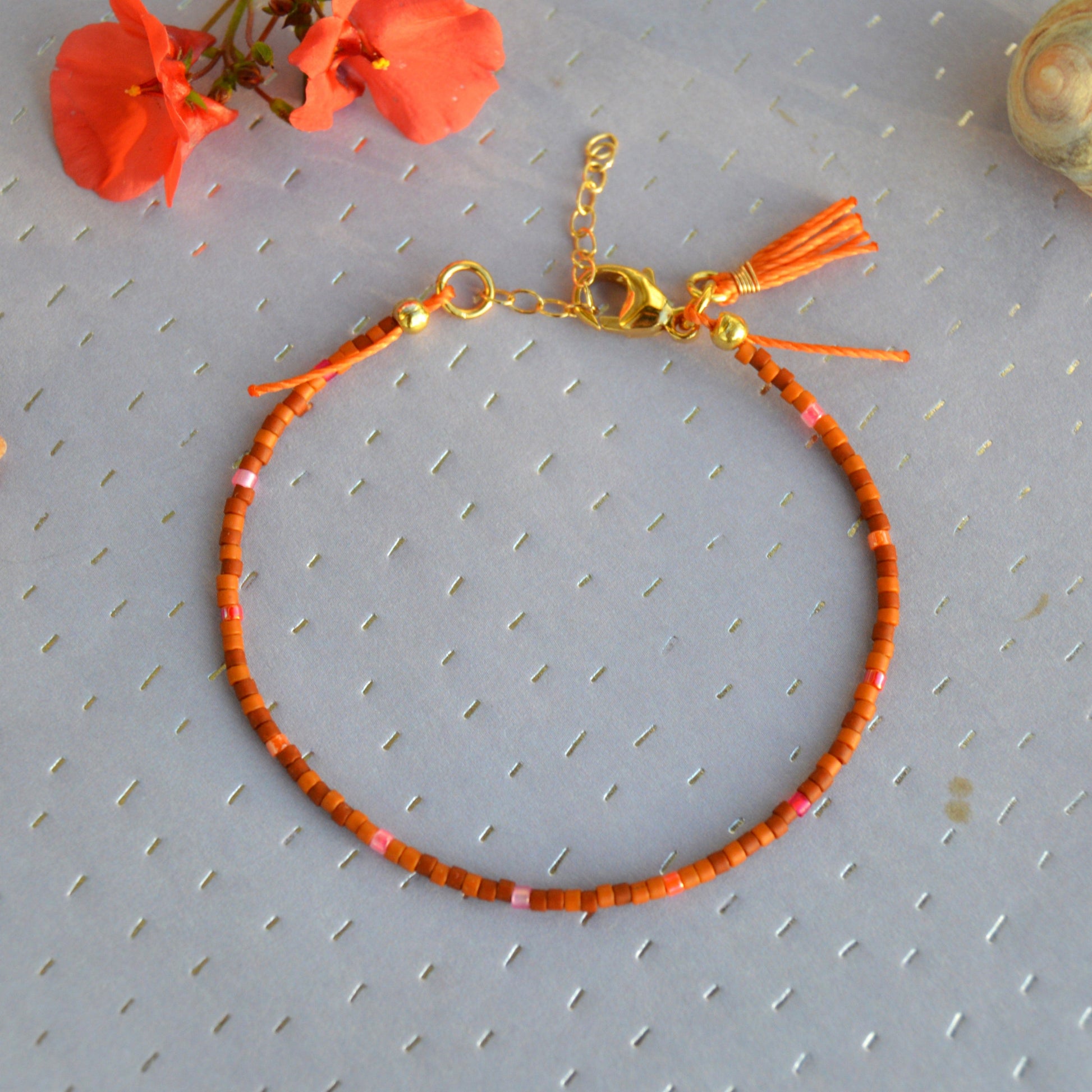 Boho beaded bracelet with a tassel - orange.