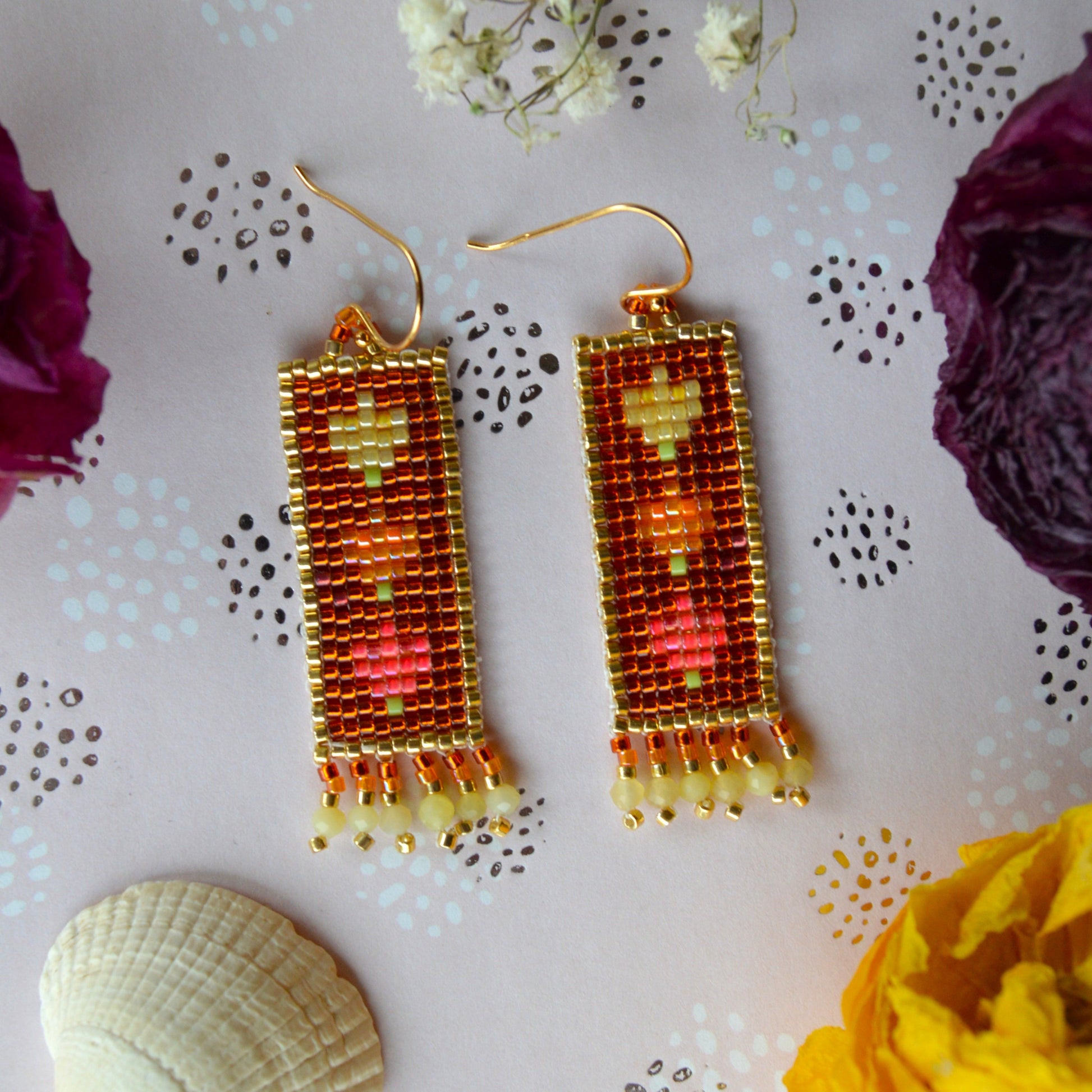 Woven Folklore Flowers earrings with yellow opal gemstones.