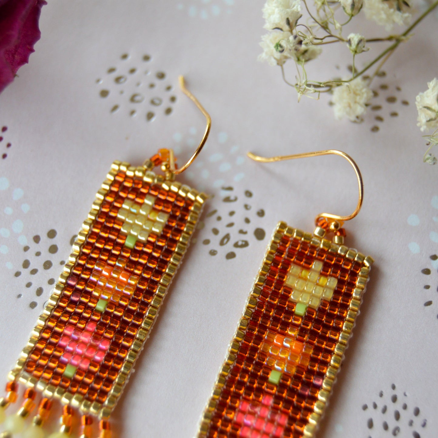 Woven Folklore Flowers earrings with yellow opal gemstones.