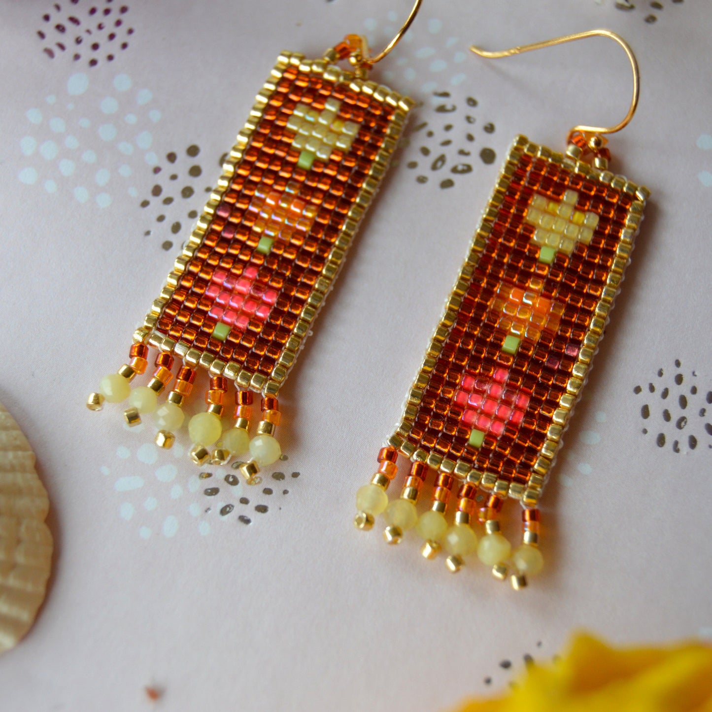 Woven Folklore Flowers earrings with yellow opal gemstones.