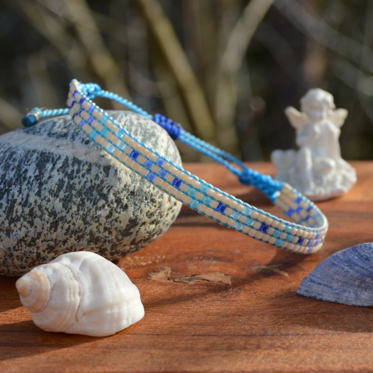 Woven bracelet with Flower design made of Japanese glass seed beads with macrame details.