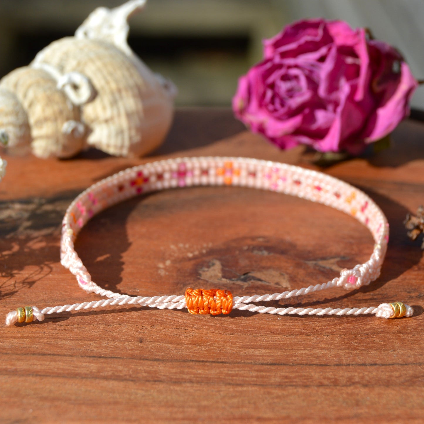 Woven beaded bracelet made of Japanese seed beads with macrame details.