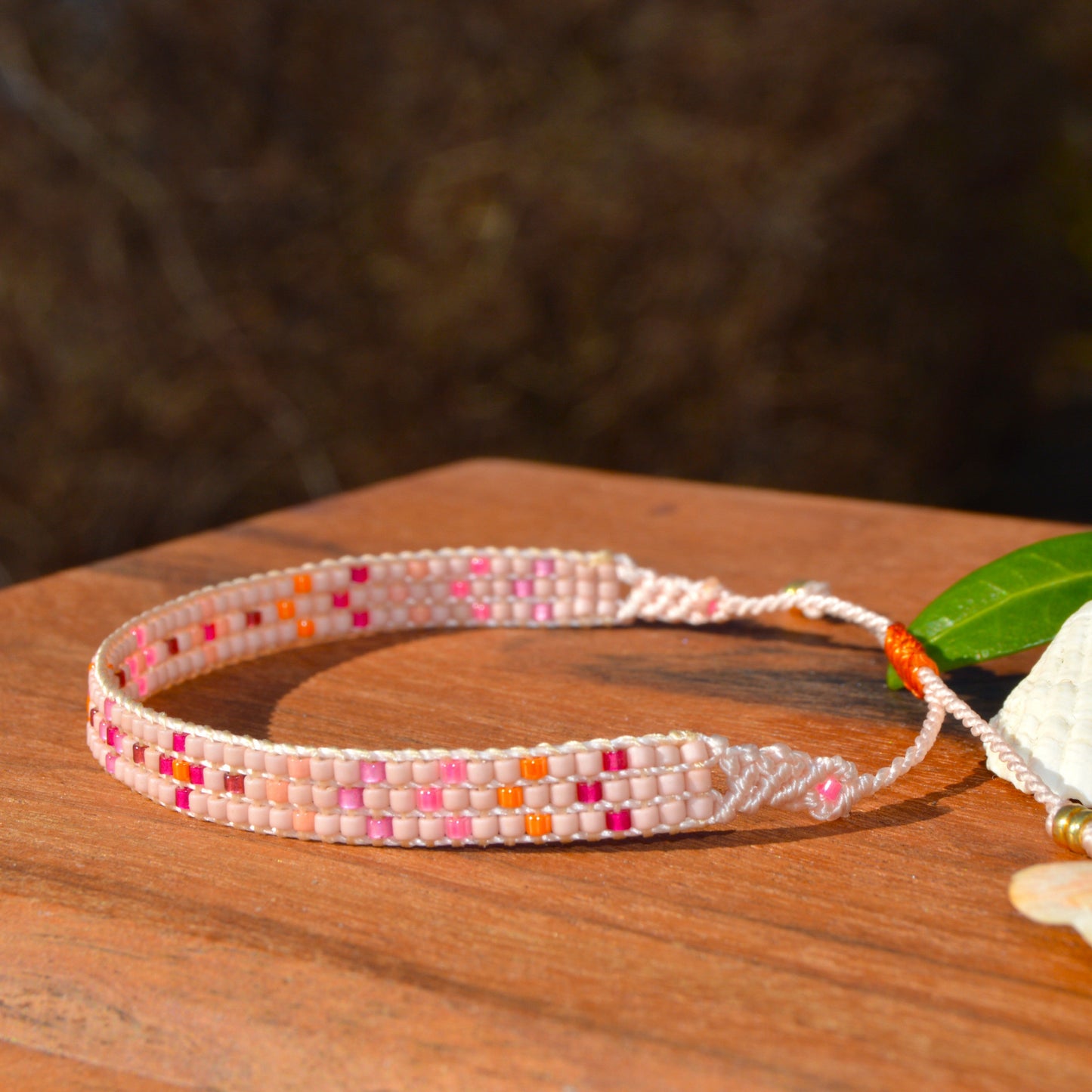 Woven beaded bracelet made of Japanese seed beads with macrame details.