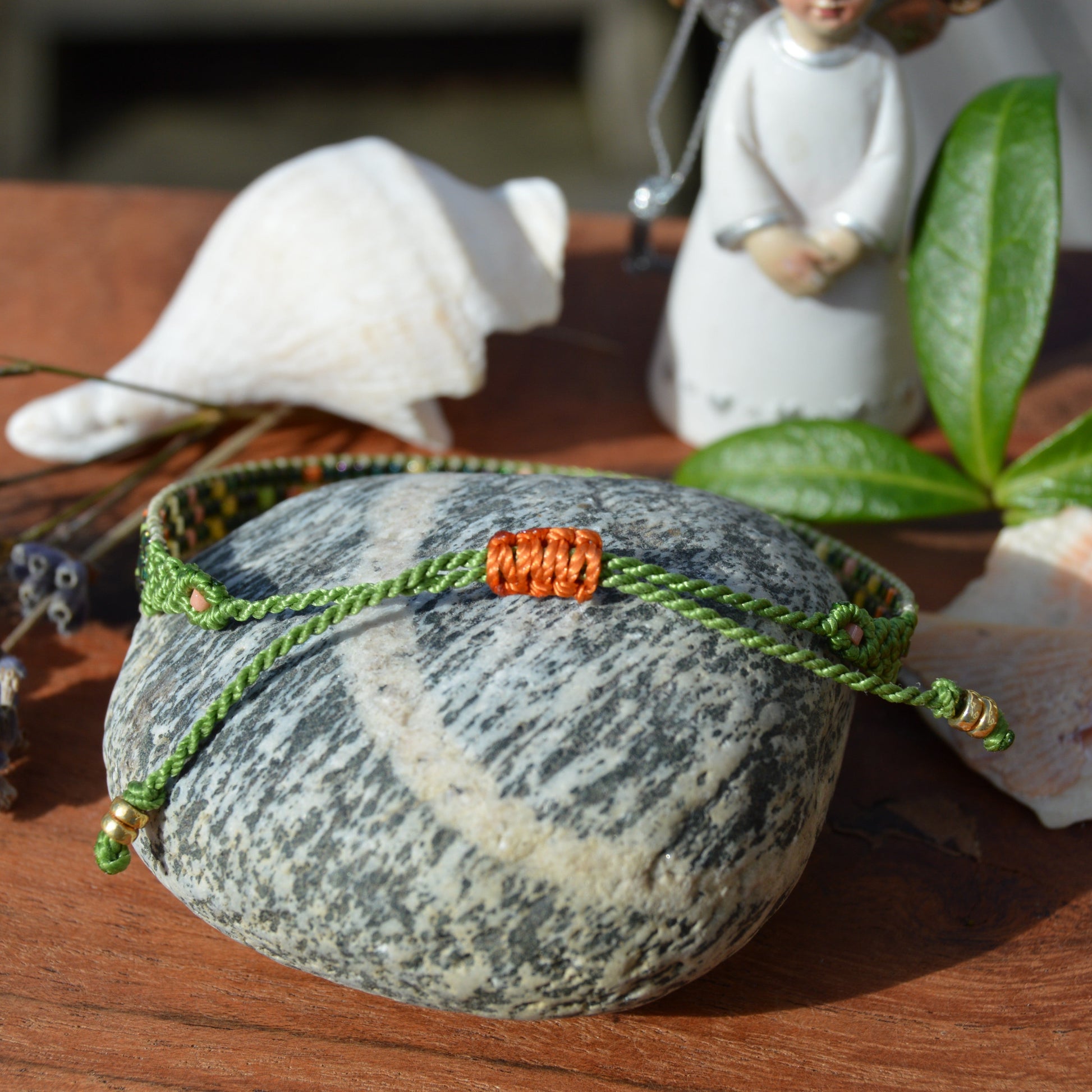 Woven beaded bracelet made of Japanese seed beads with macrame details.