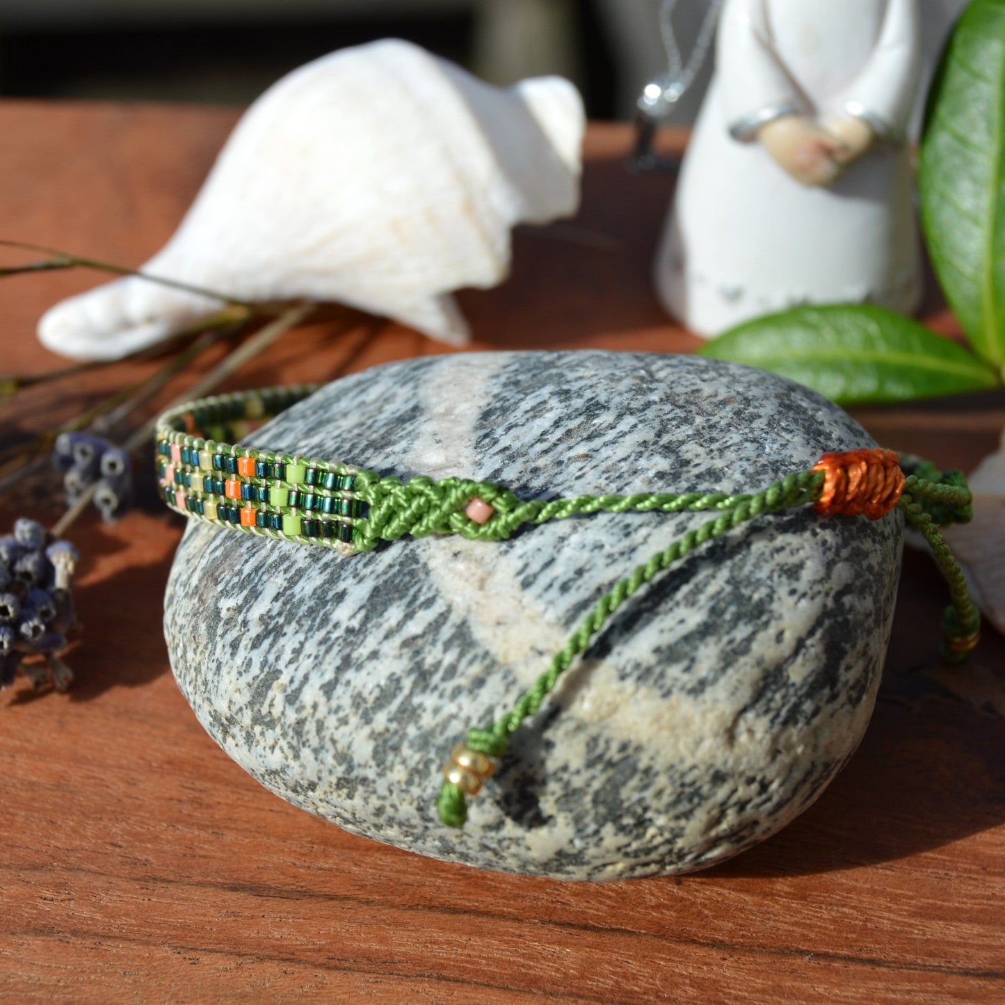 Woven beaded bracelet made of Japanese seed beads with macrame details.