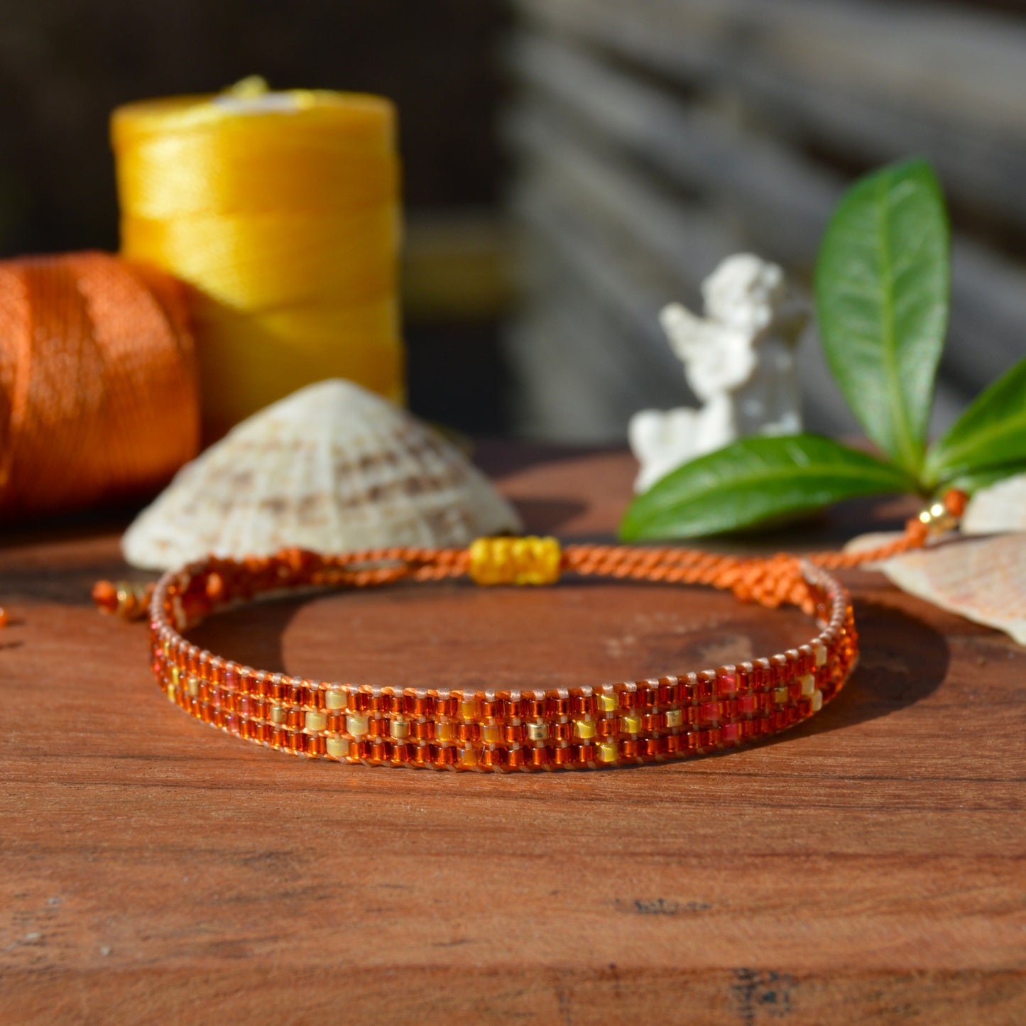 Woven bracelet with Flower design made of Japanese glass seed beads with macrame details.