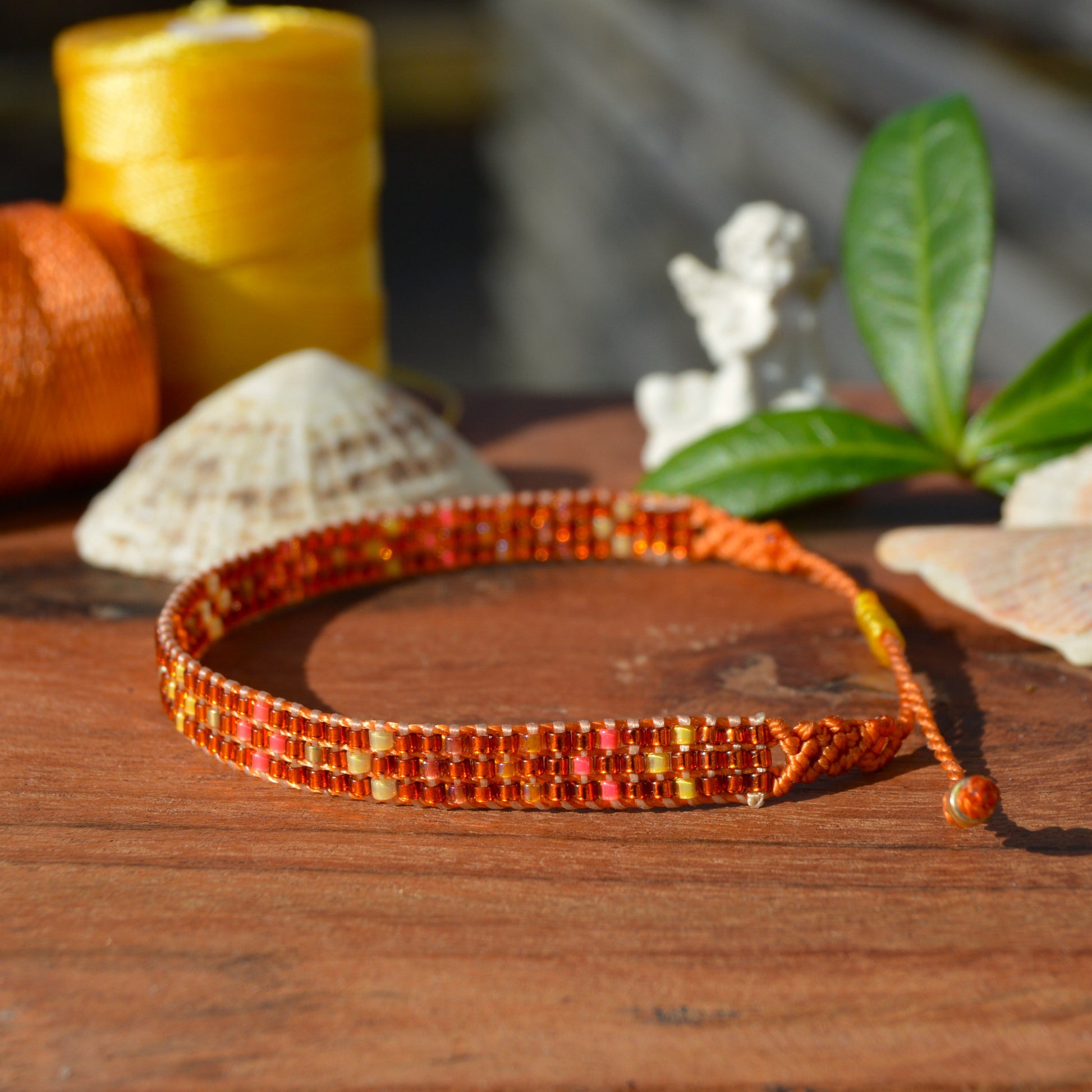 Woven bracelet with Flower design made of Japanese glass seed beads with macrame details.