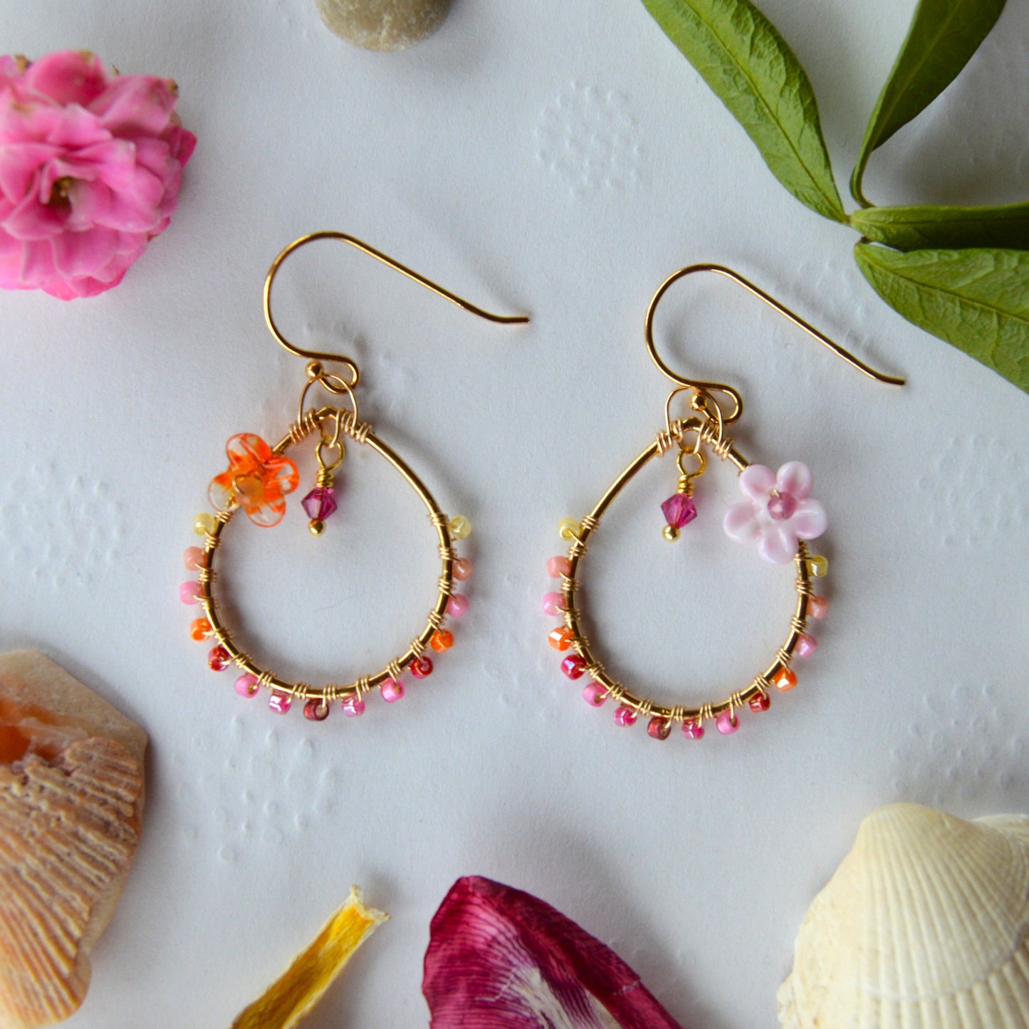 Delicate drop earrings wire-wrapped with Japanese seed beads in pink tones and lampwork glass beads.
