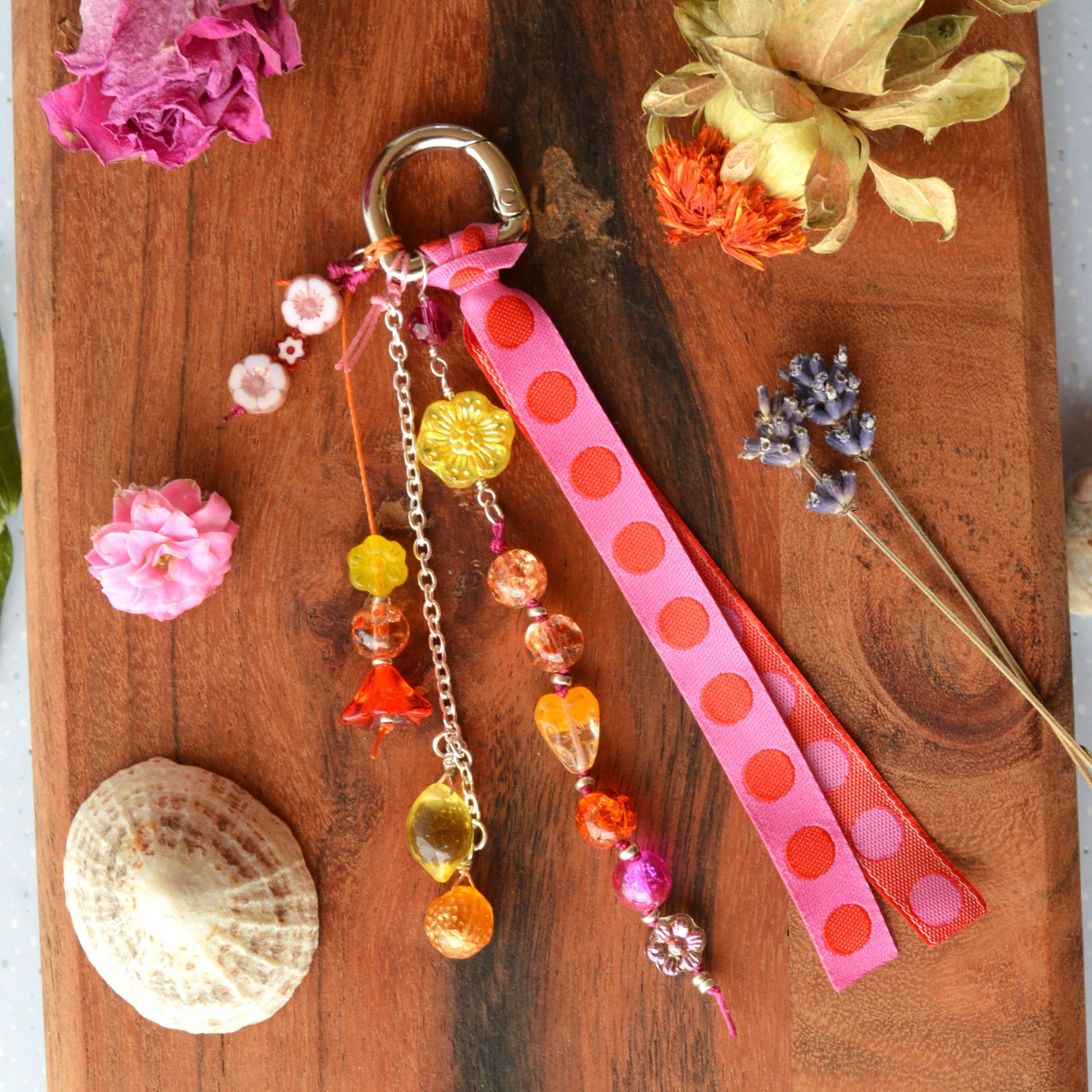 Handbag charm with Czech beads and ribbon in yellow, orange, pink, and red tones.